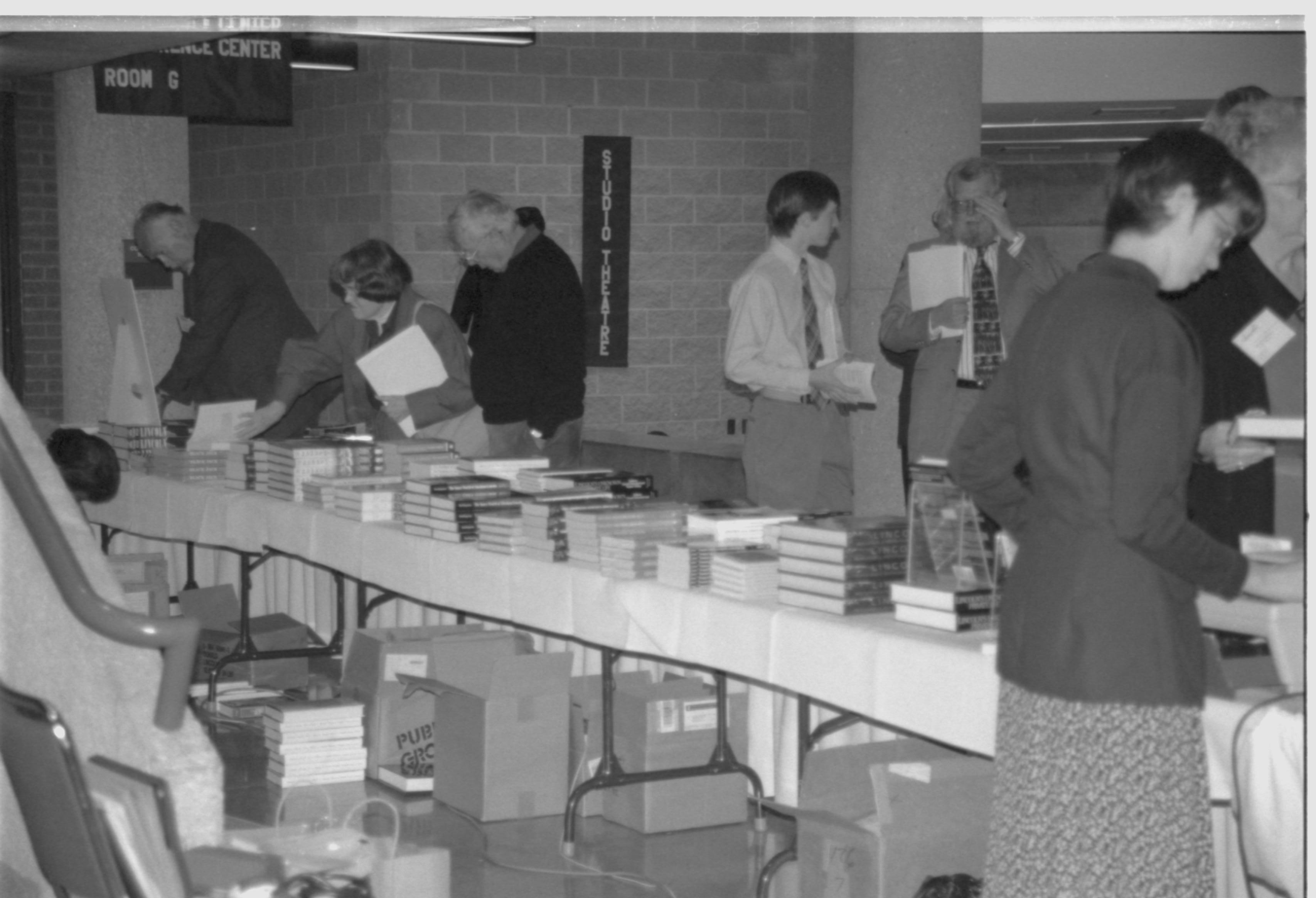 Distant shot of attendees at book table. Lincoln Colloquium; 88257 Lincoln, Colloquium