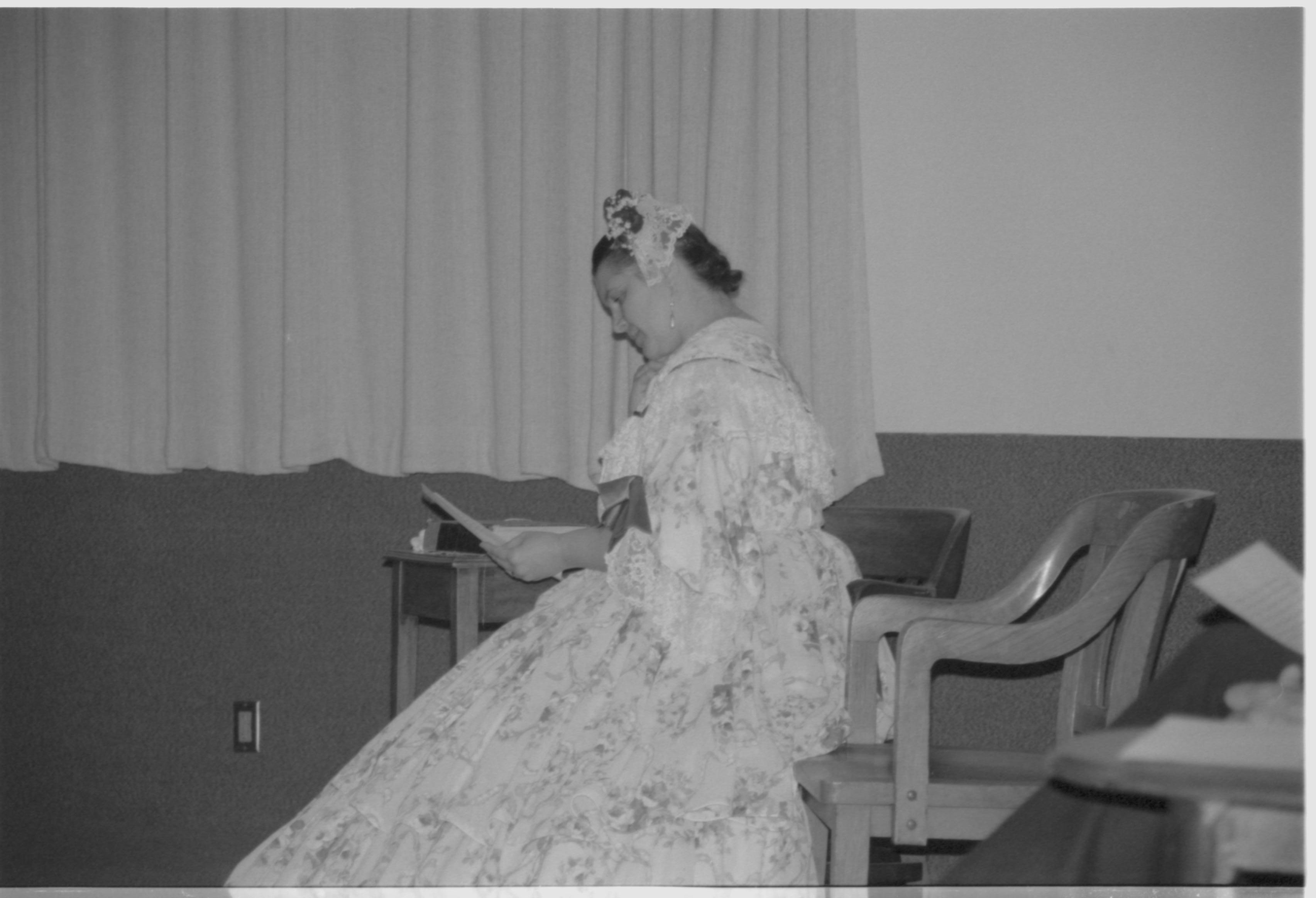 Lady in period dress sitting on chair. Lincoln Colloquium; 88257 Lincoln, Colloquium