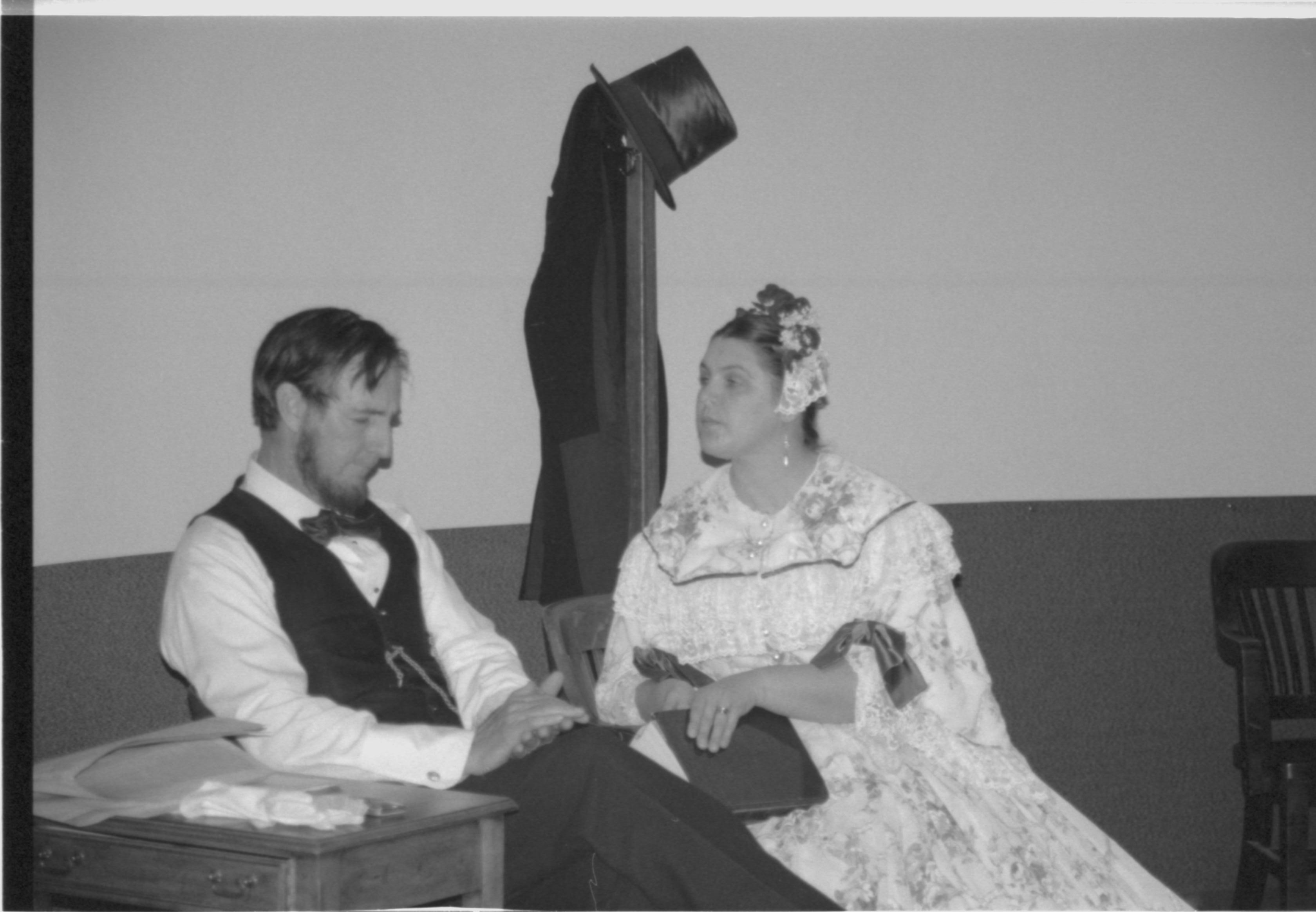 Couple in period dress sitting, talking to each other. Lincoln Colloquium; 88257 Lincoln, Colloquium