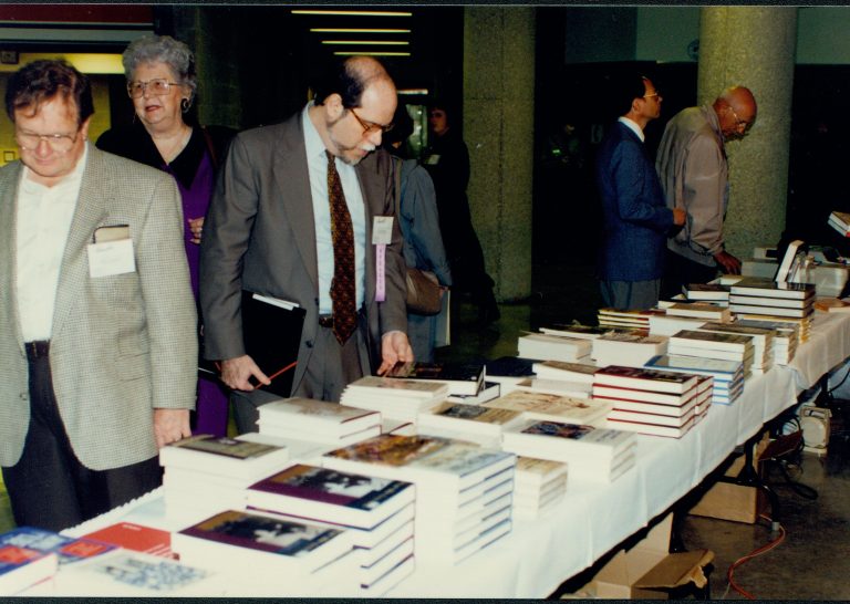 Participant looking at books. Lincoln Colloquium; 56934 Lincoln, Colloquium