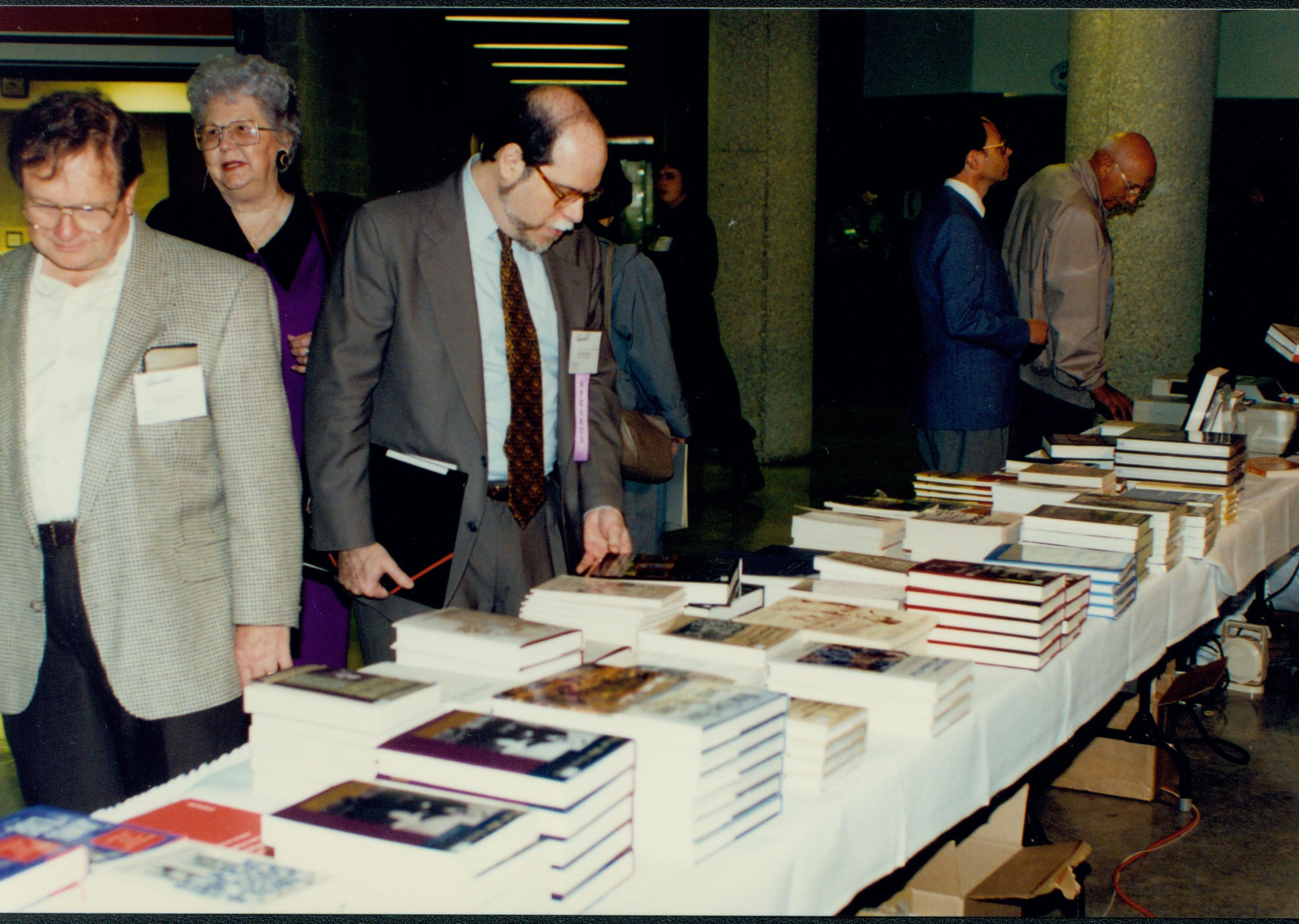Participant looking at books. Lincoln Colloquium; 56934 Lincoln, Colloquium