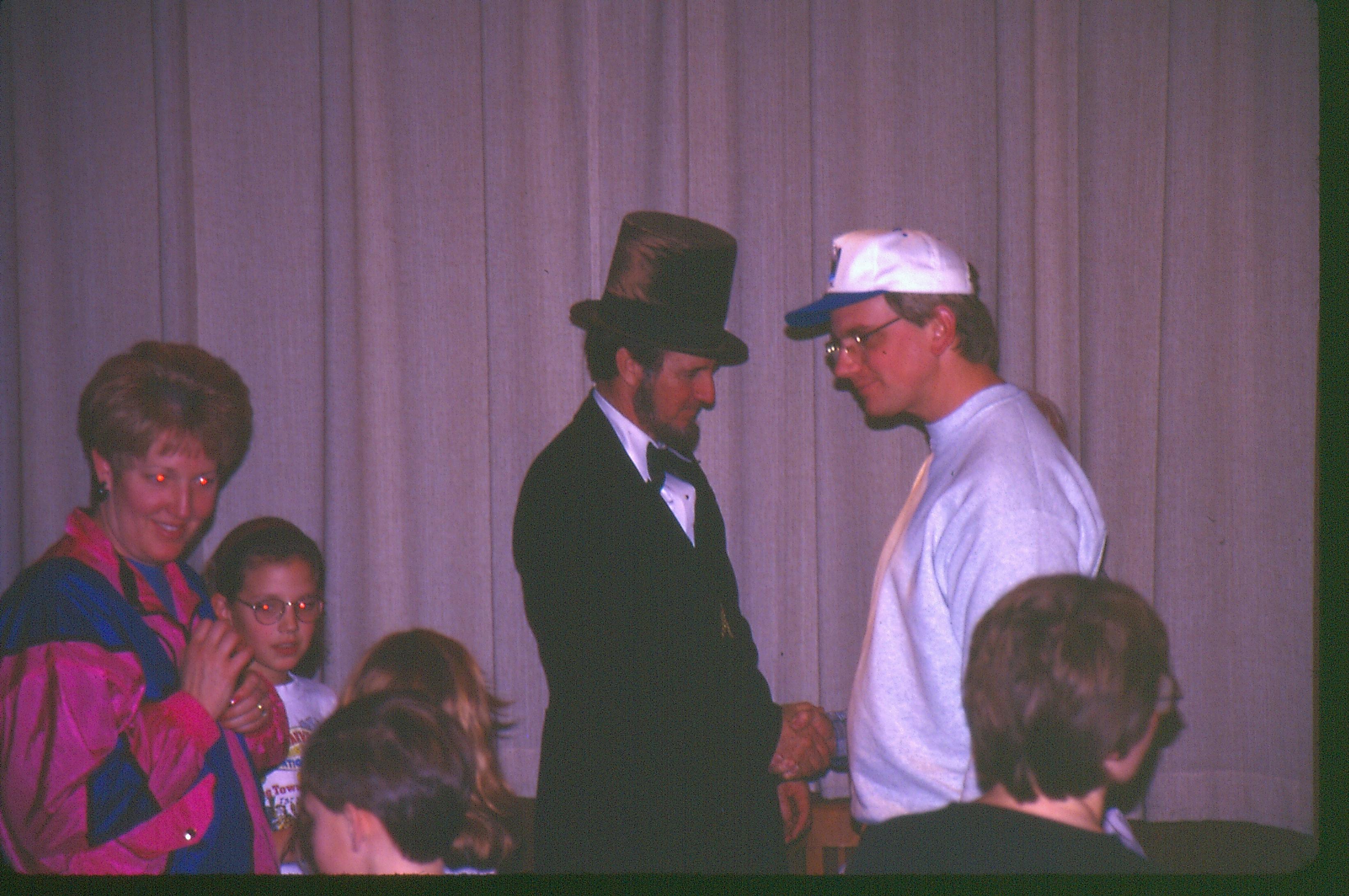 Reenactor shaking hands with visitor. Lincoln Colloquium Lincoln, Colloquium