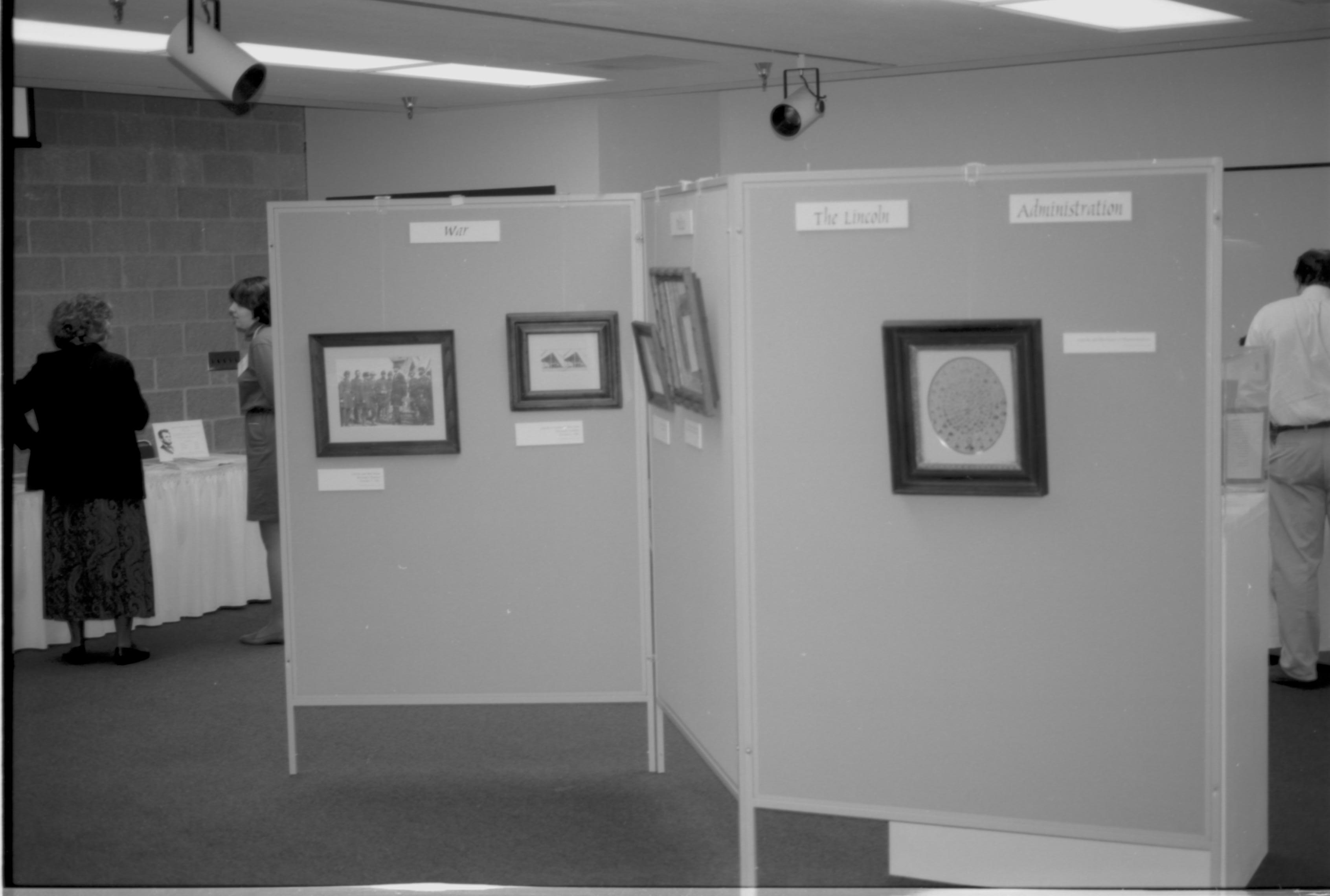 Photographs hanging on display. Lincoln Colloquium; UIS Roll#1, 4of4 Lincoln, Colloquium