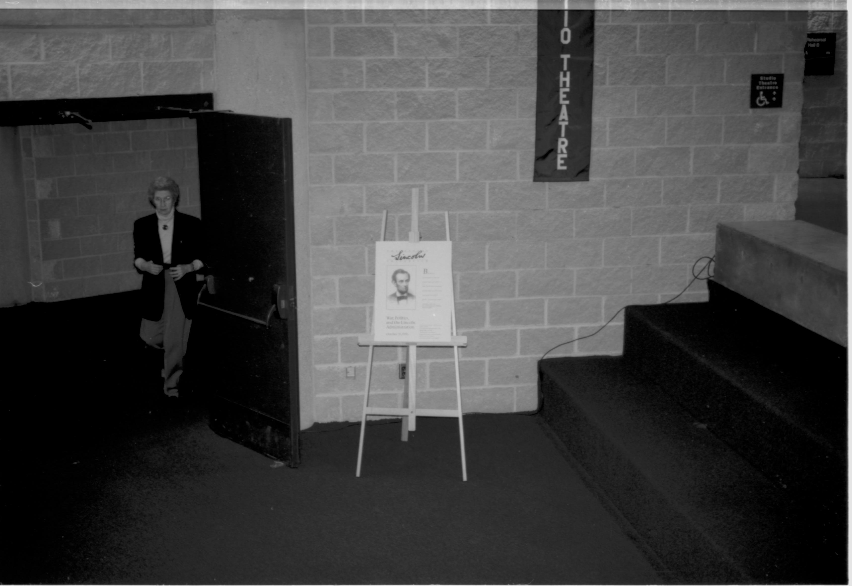 Lady exiting through doors. Lincoln Colloquium; UIS Roll#1, 4of4 Lincoln, Colloquium