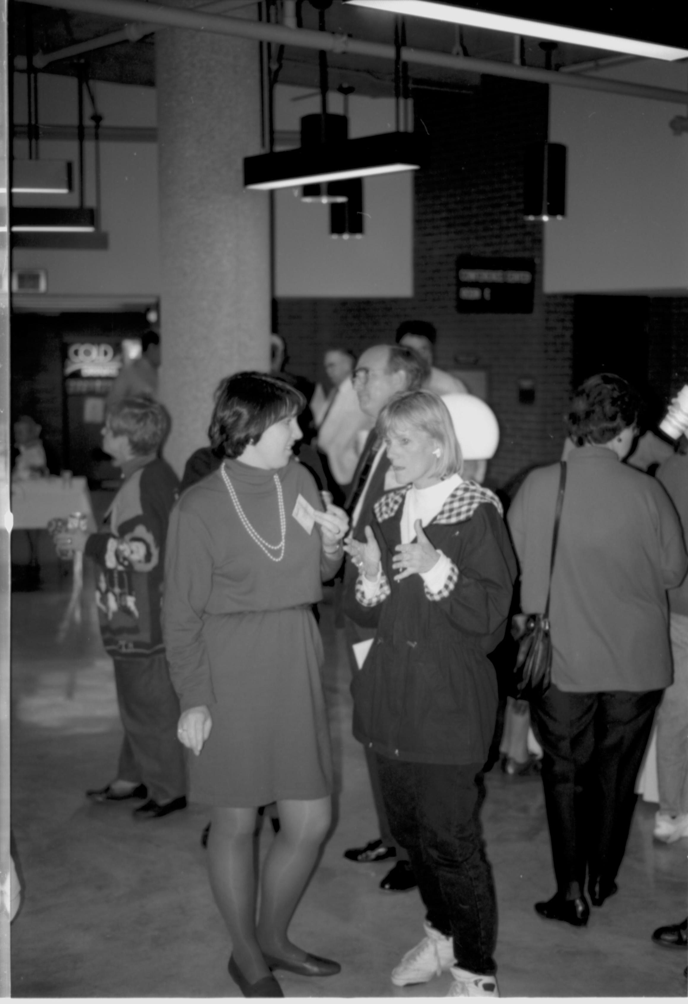 Two ladies talking to each other.  Lincoln Colloquium; UIS Roll#1, 4of4 Lincoln, Colloquium