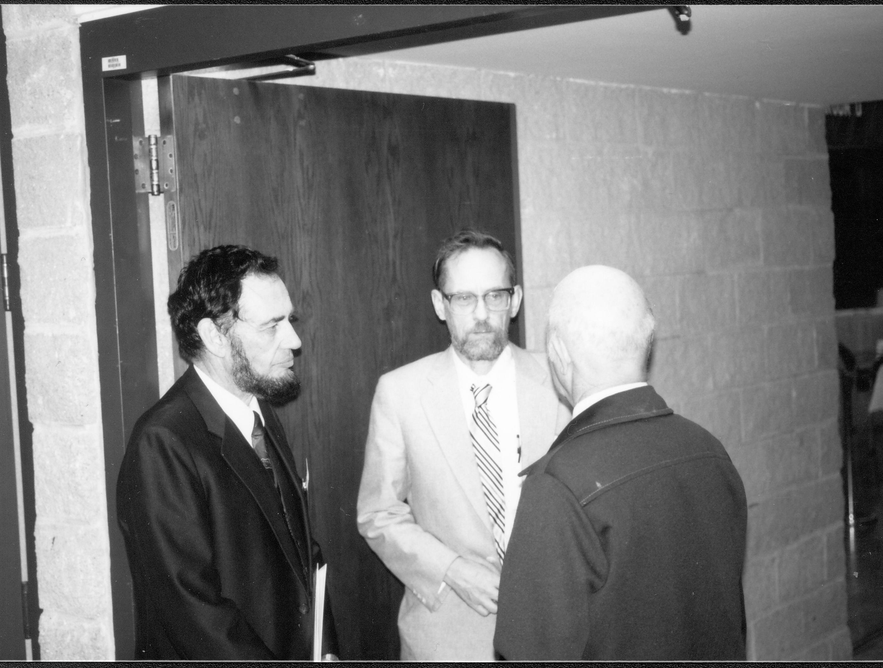 Three men standing in doorway talking. Lincoln Colloquium; UIS Roll#2, 2of4 Lincoln, Colloquium