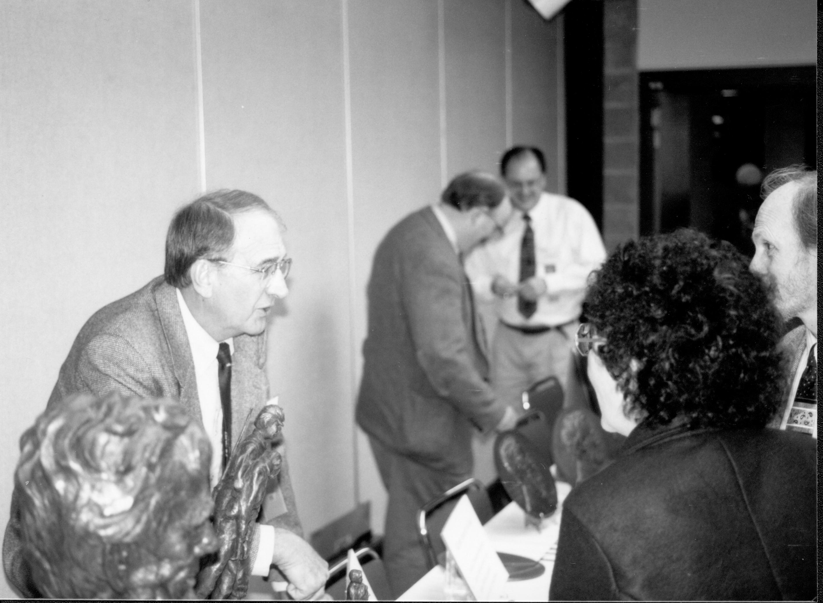 Man behind schulpture talking to two visitors. Lincoln Colloquium; UIS Roll#2, 1of4 Lincoln, Colloquium