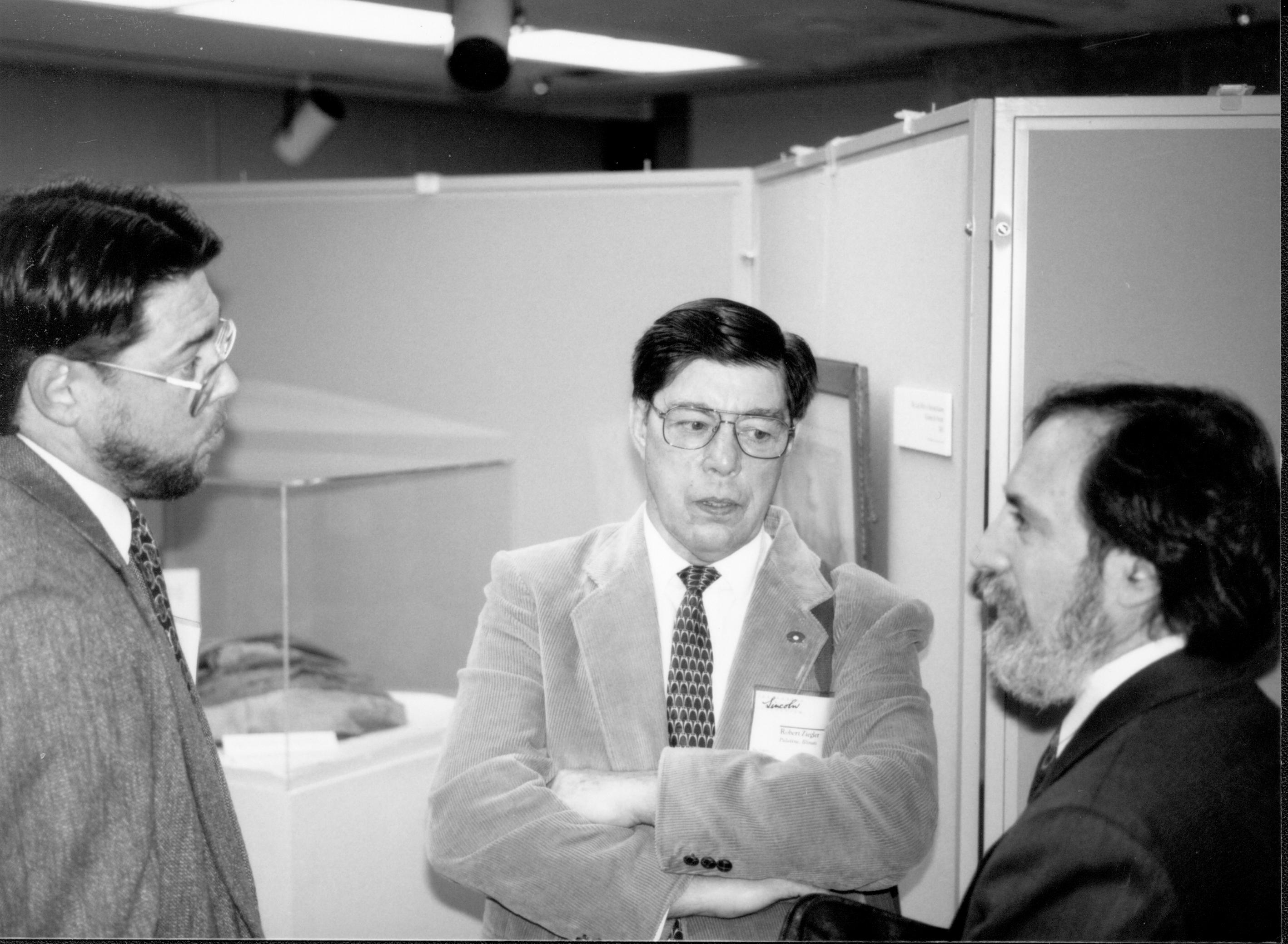 Three men, one with arms folded, talking. Lincoln Colloquium; UIS Roll#2, 1of4 Lincoln, Colloquium