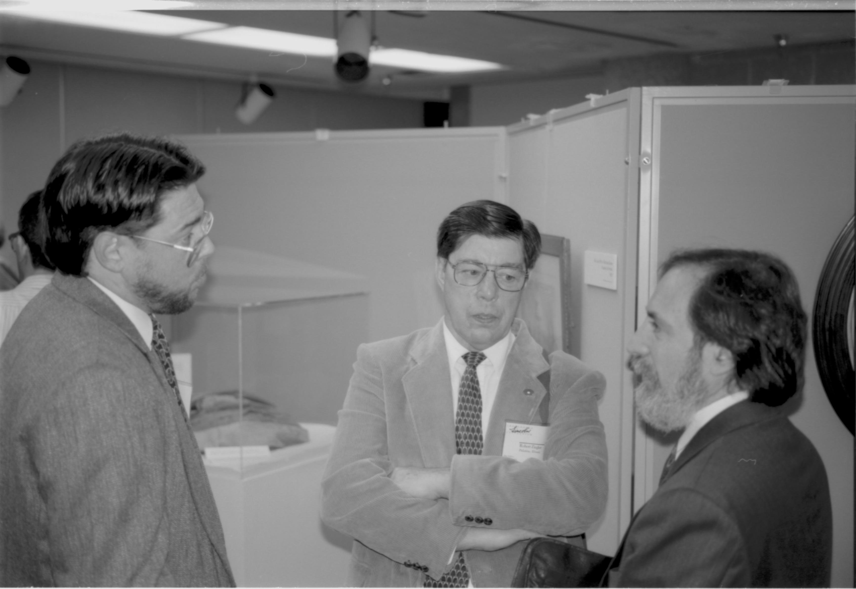 Three men, one with arms folded, talking. Lincoln Colloquium; UIS Roll#2, 4of4 Lincoln, Colloquium