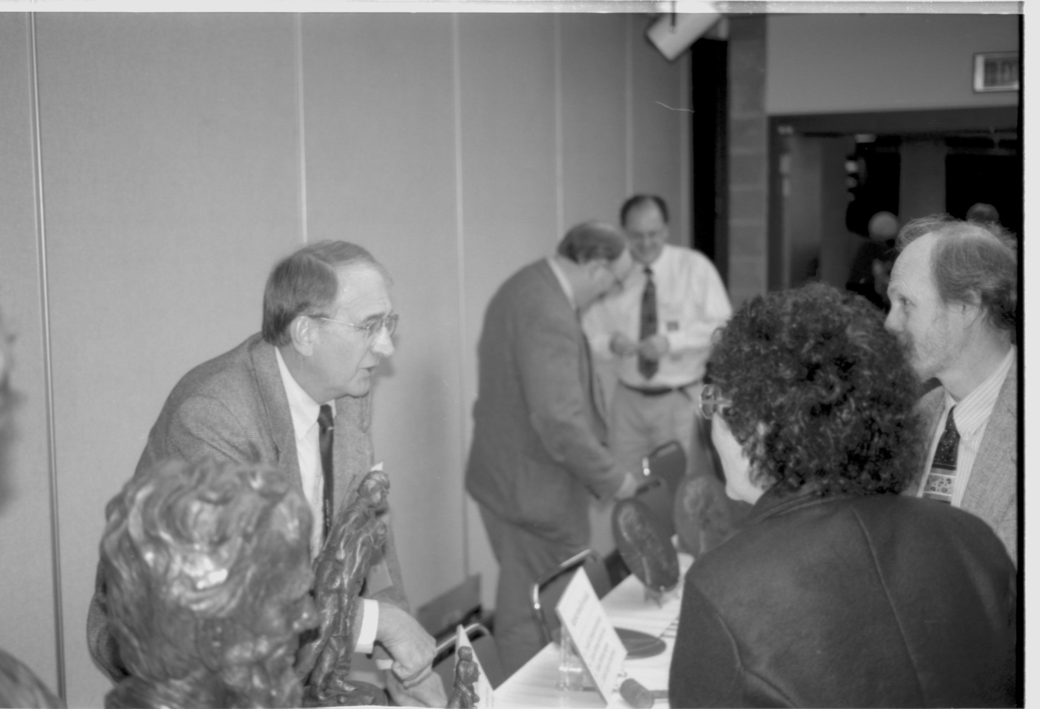 Man behind schulpture talking to two visitors. Lincoln Colloquium; UIS Roll#2, 4of4 Lincoln, Colloquium