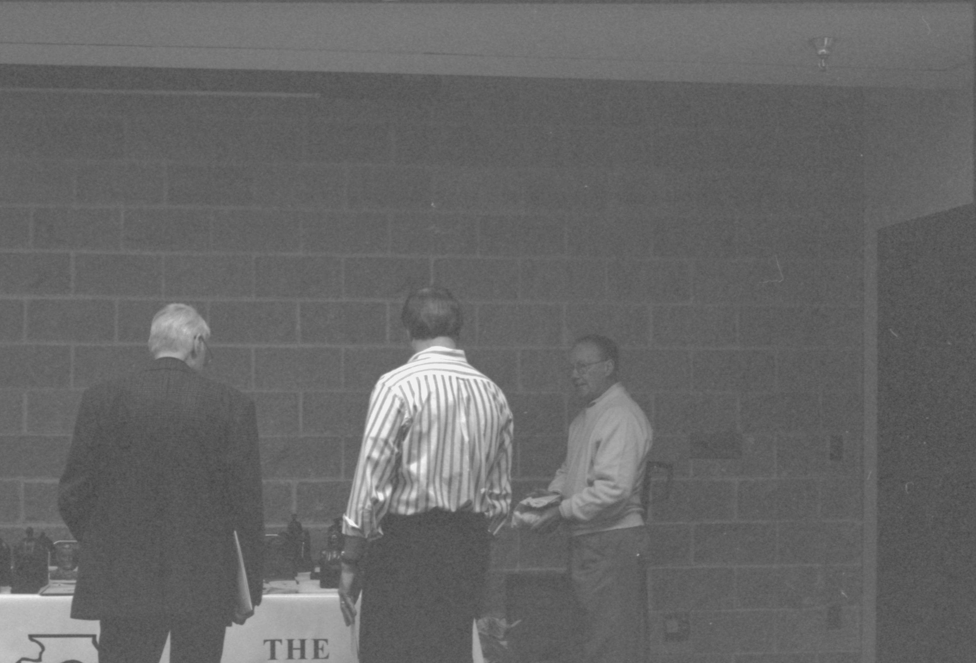 Jack Smith and other visitors at display table. 1-1997 Colloq (b/w) Colloquium, 1997