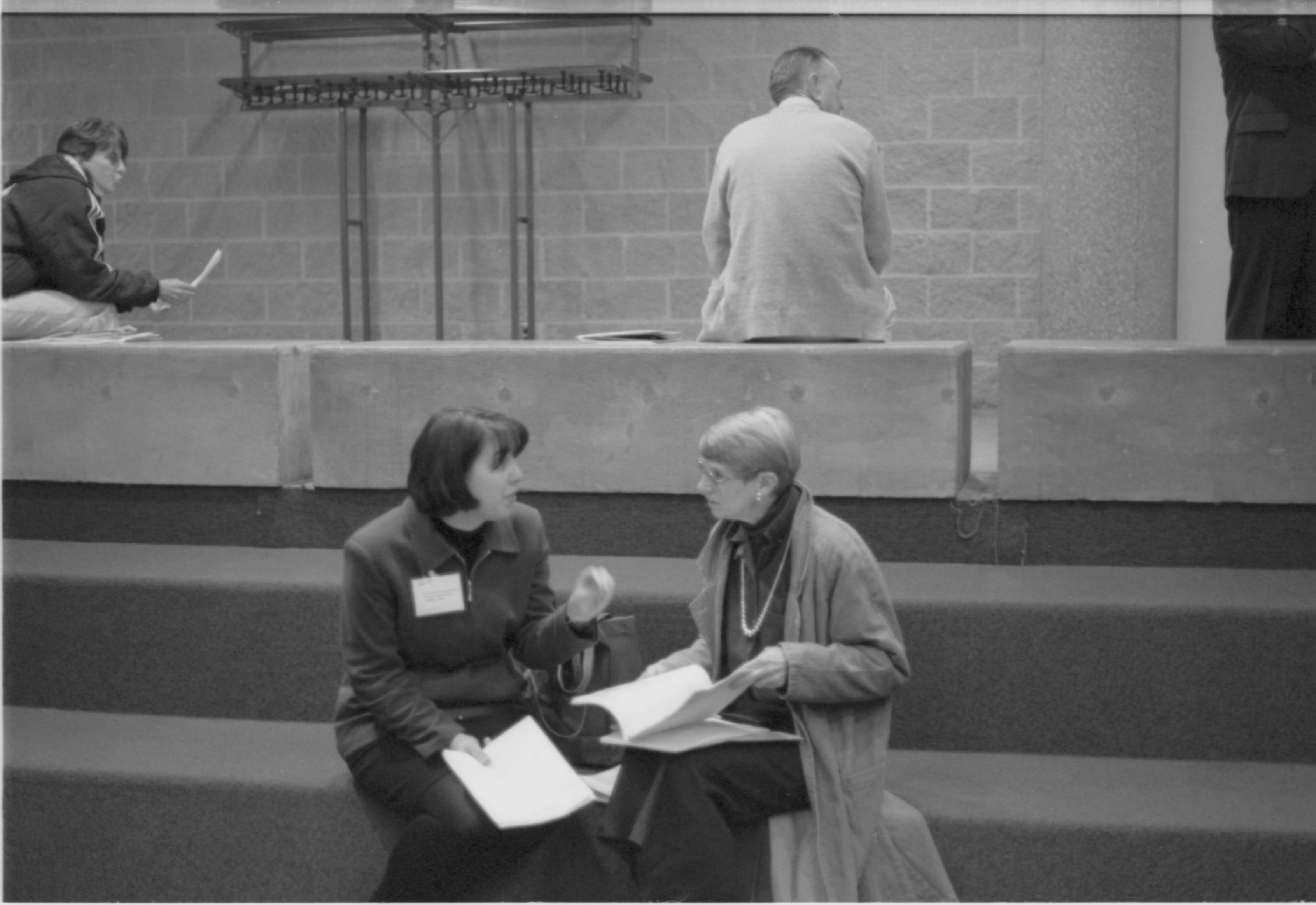 Two ladies seated on stairs. 1-1997 Colloq (b/w) Colloquium, 1997