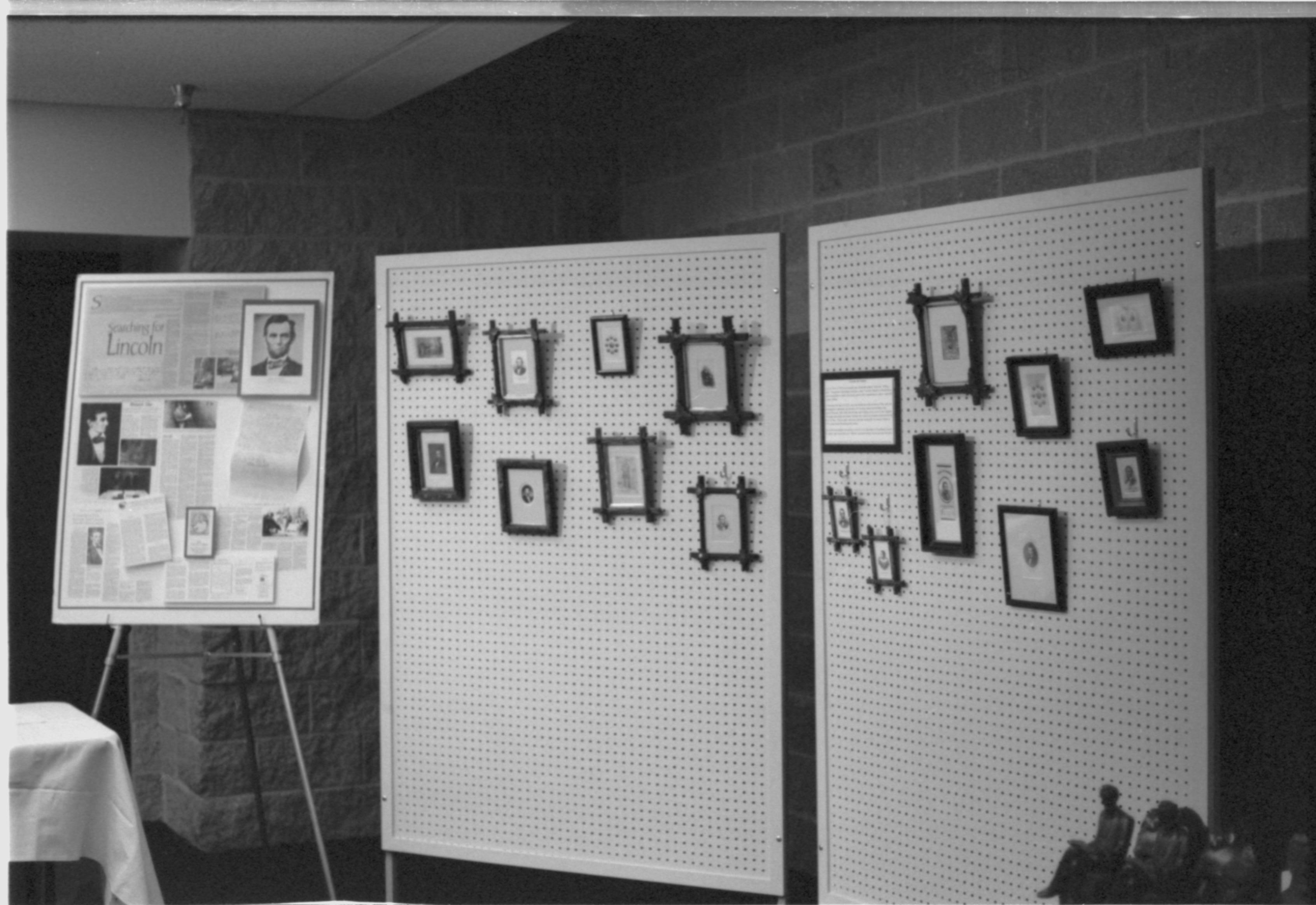 Pictures hanging on peg board. 3-1997 Colloq (b/w); 9    Jack Smith exhibit. Colloquium, 1997