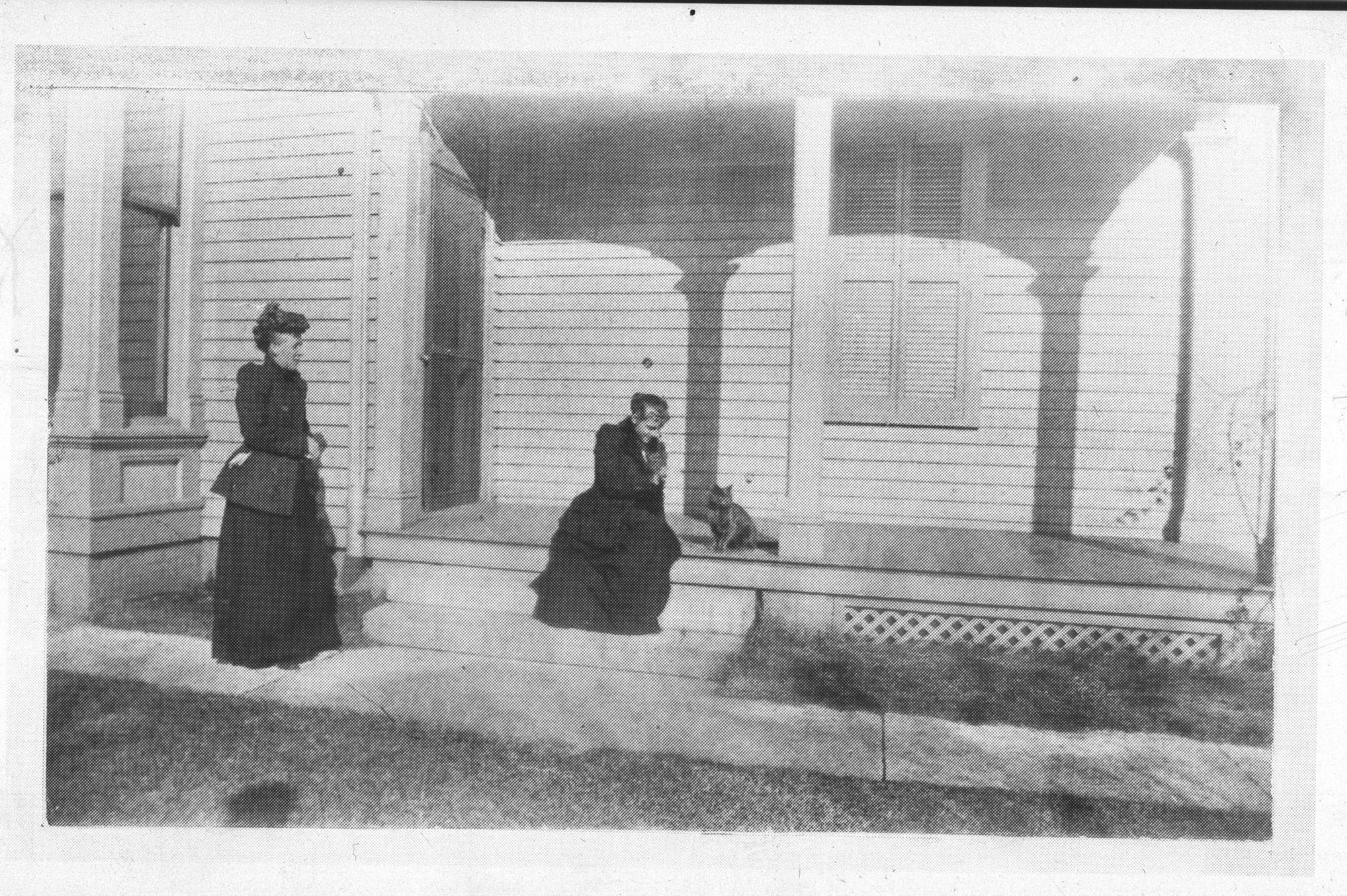 Two ladies and a cat by house. Robinson house, South Eighth street. Portraits, Robinson