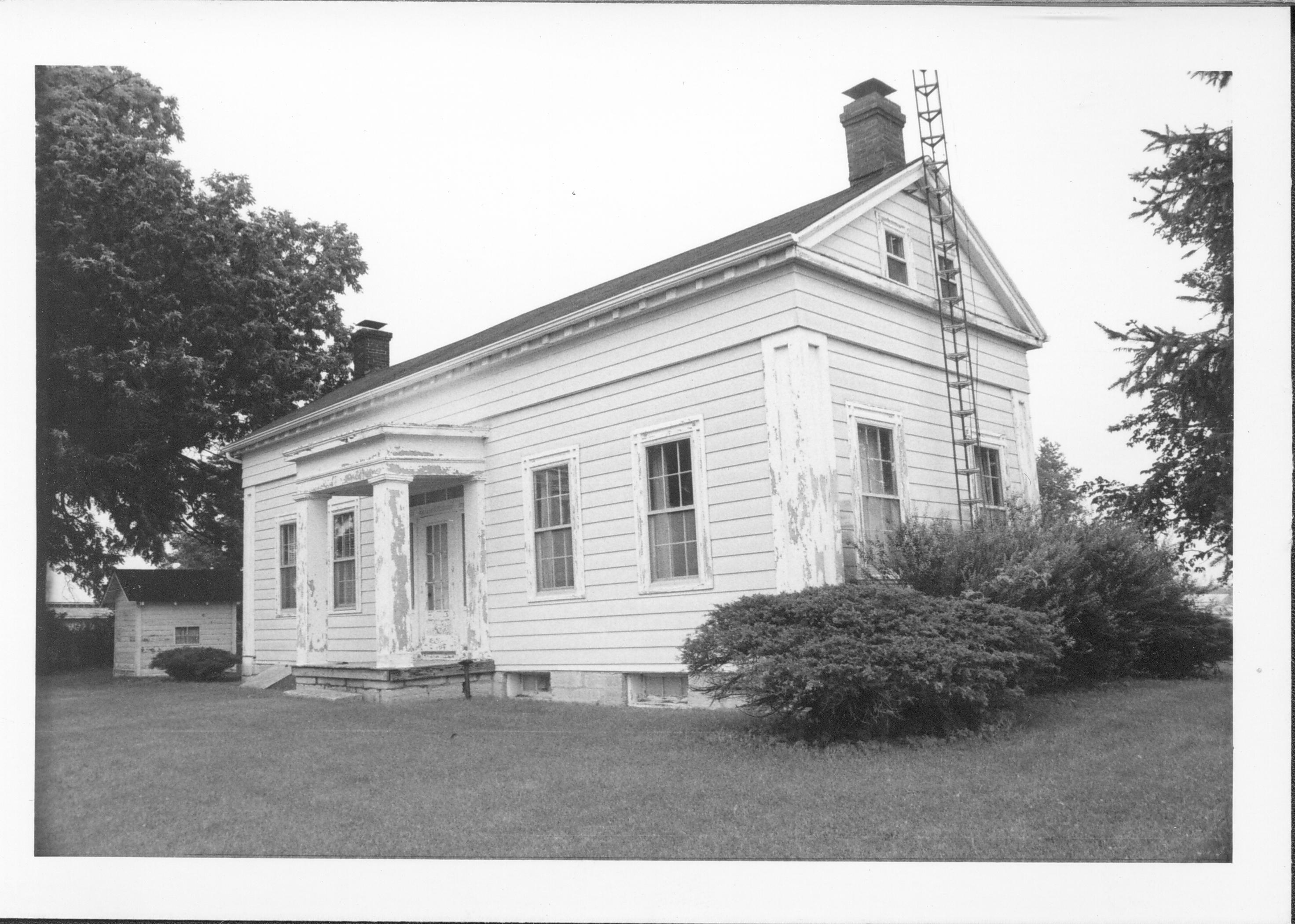 White single story house with TV tower on side. Gardner-McMillan