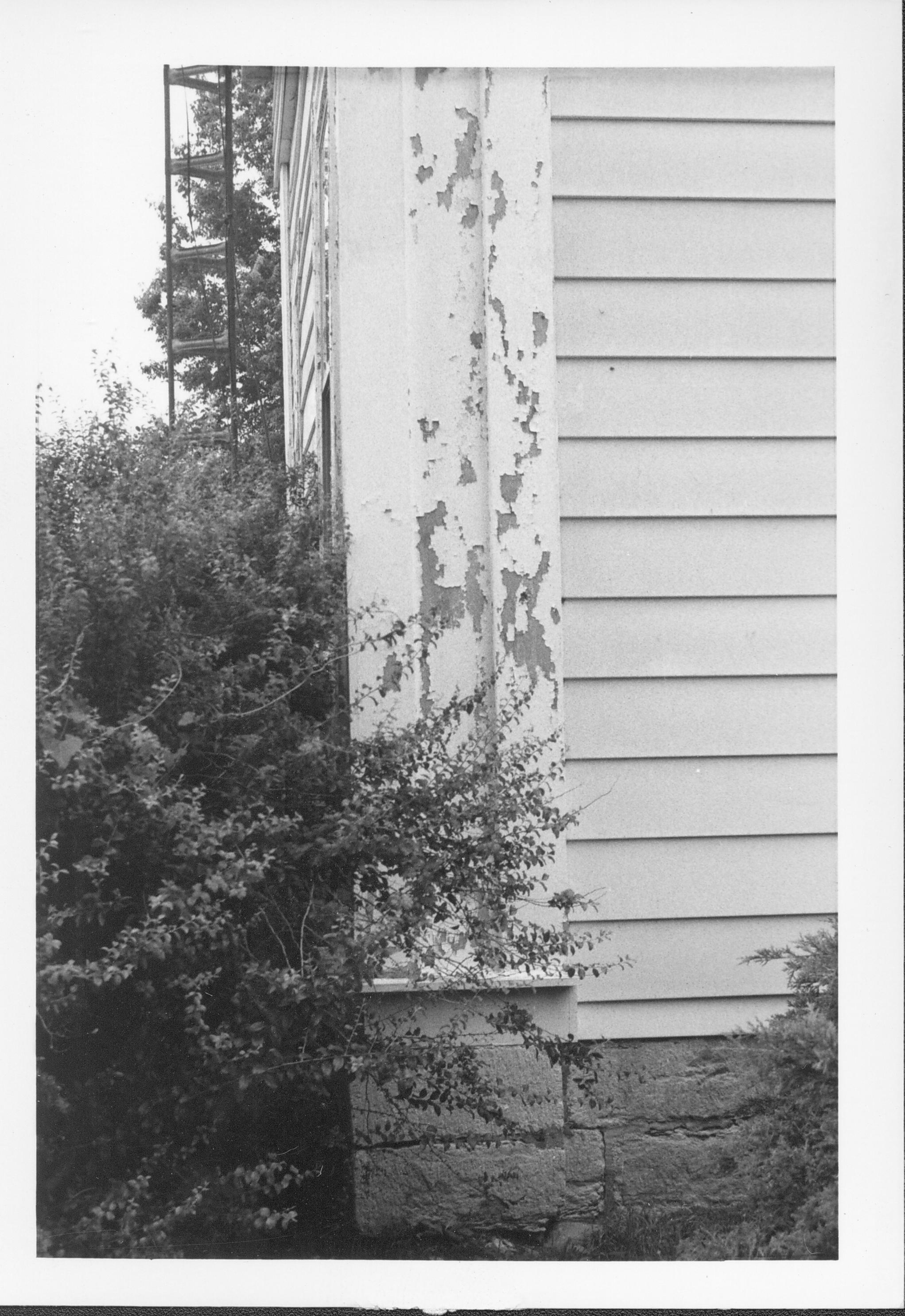 Corner picture of white house and peeling paint. Gardner-McMillan