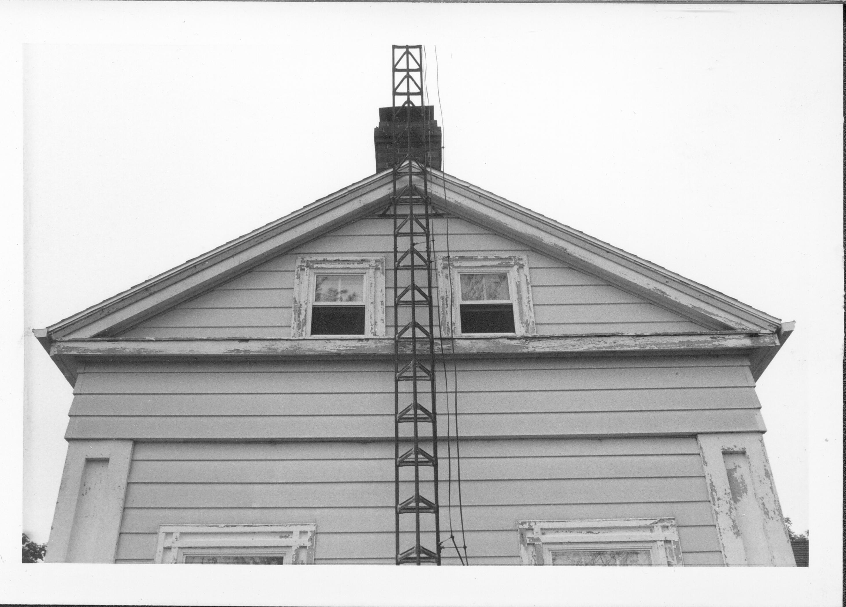 End view of white house attic windows and TV tower. Gardner-McMillan