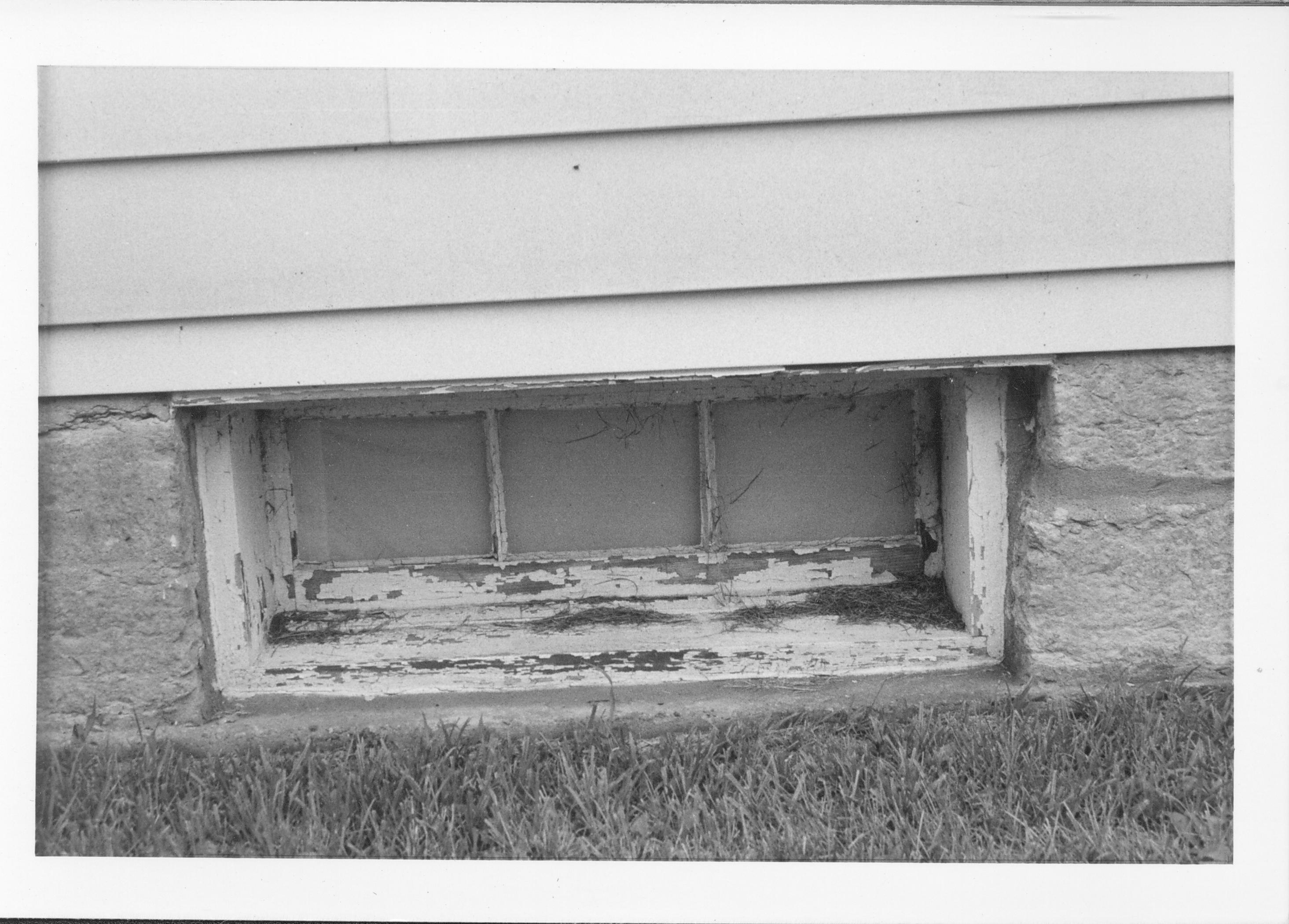 Exterior of basement window in need of paint. Gardner-McMillan