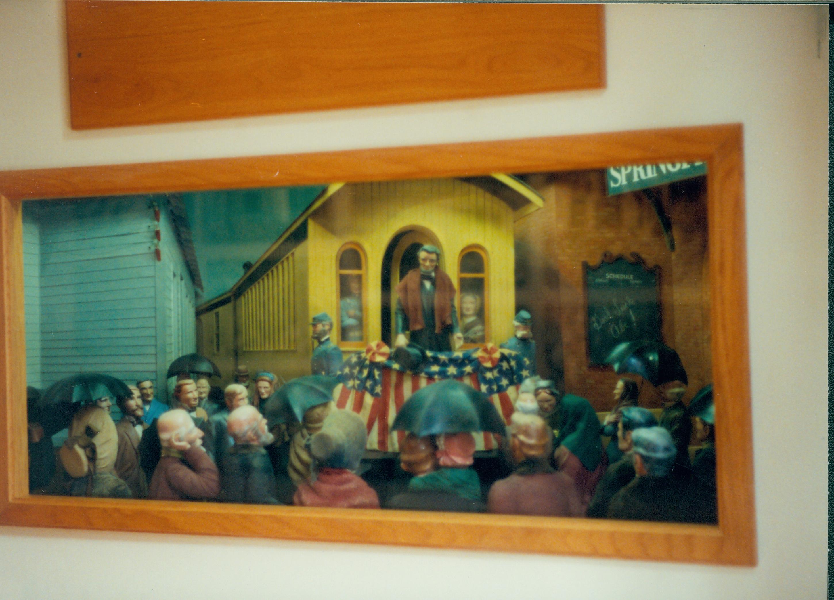 Diorama of man standing on back of train car. Great Western Depot, Train Station