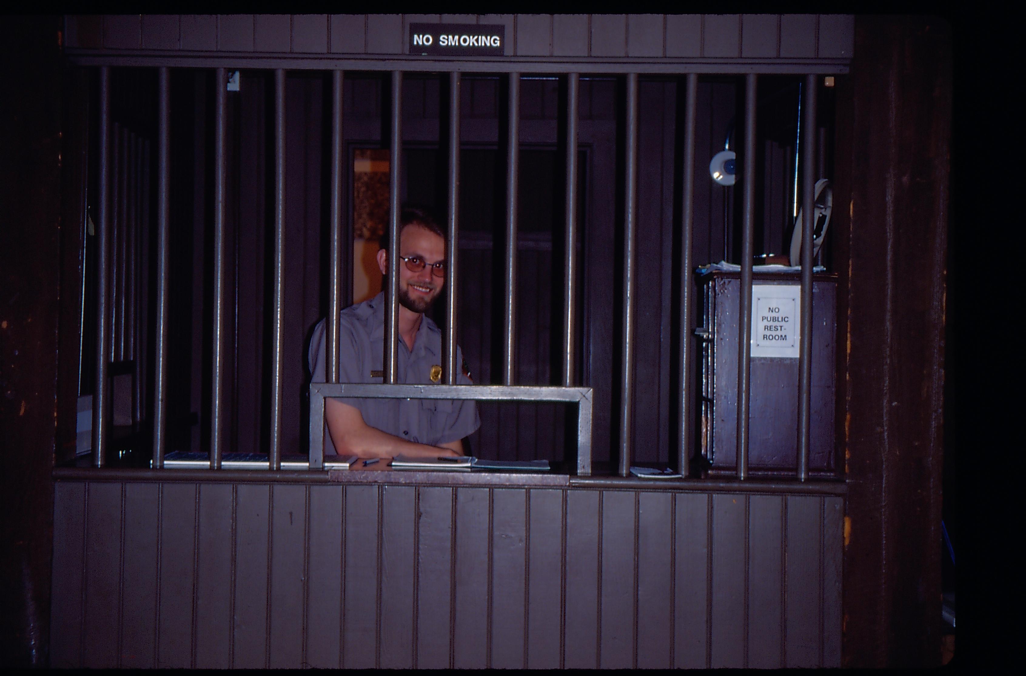 Ranger behind ticket cage. Great Western Depot, Train Station