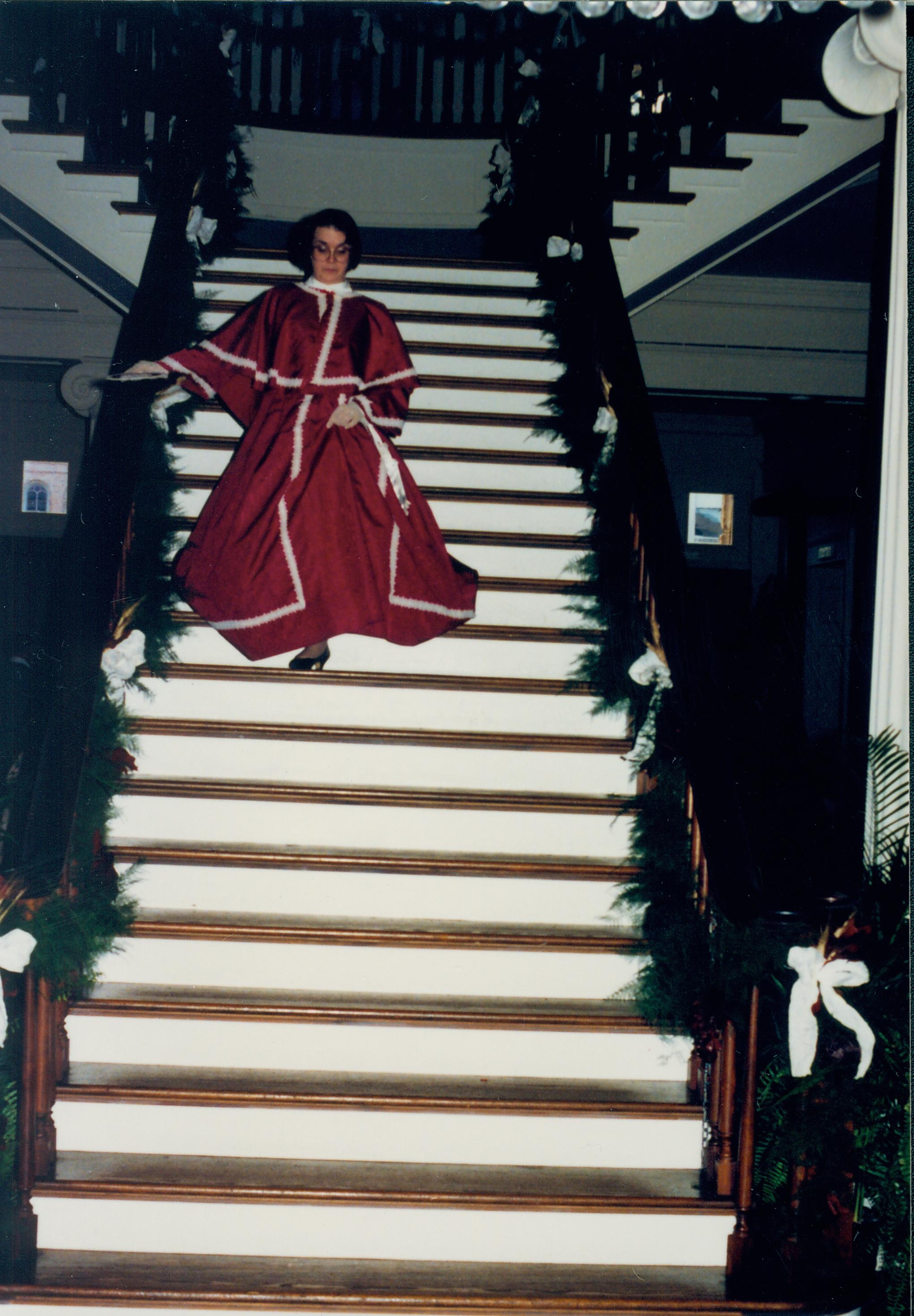 Lady in period dress descending stairs. Old State Capitol, Springfield, IL. Old State Capitol, Decorations