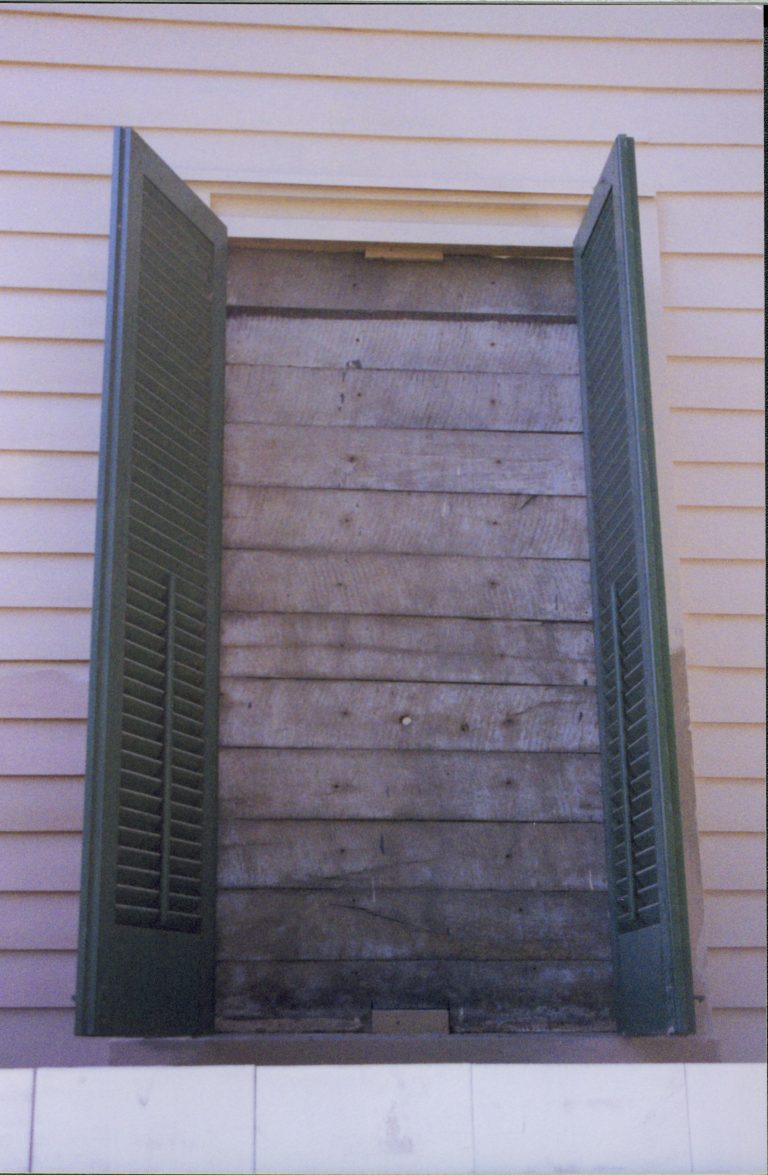 Exposed 1850s siding under shutter 22 