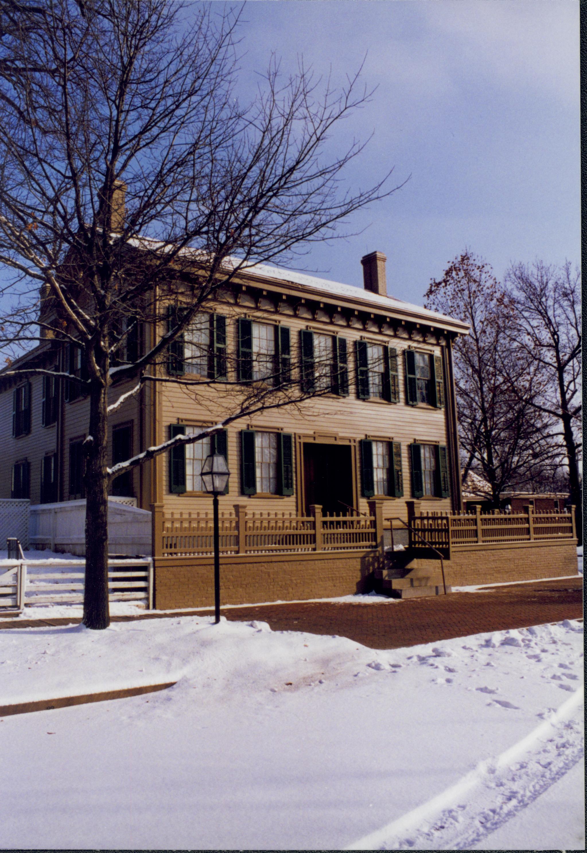 Lincoln Home in the snow, brick plaza in front cleared of snow.  Some footprints and maintenance vehicle tracks visible. Looking East/Southeast from 8th Street snow, Lincoln Home, 8th Street, brick plaza