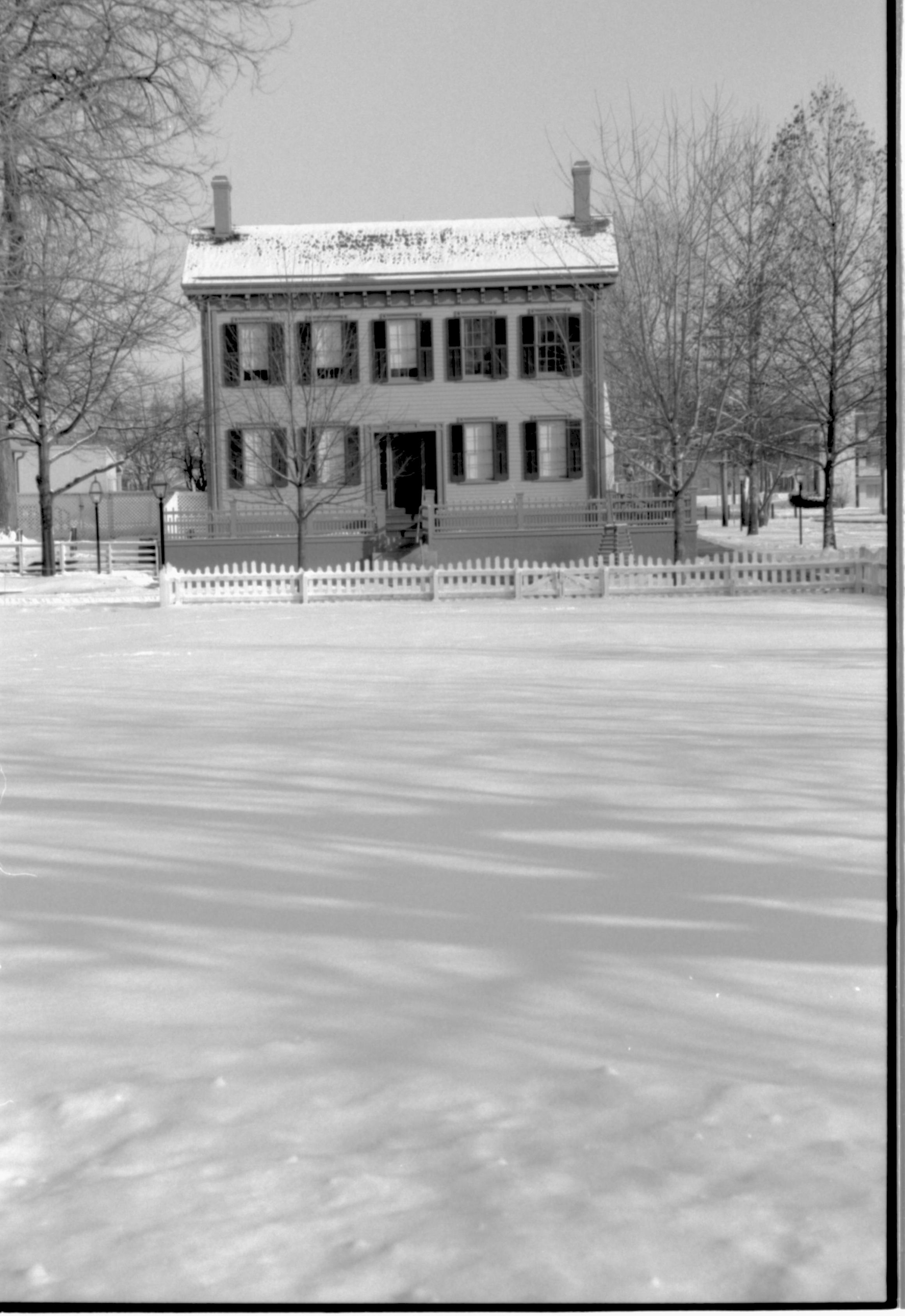 Lincoln Home in the snow. B-2 in background left, former Travel Lodge Motel in background right. Burch lot in foreground Looking East from Burch Lot, Block 7, Lot 9 snow, Lincoln Home, Burch Lot