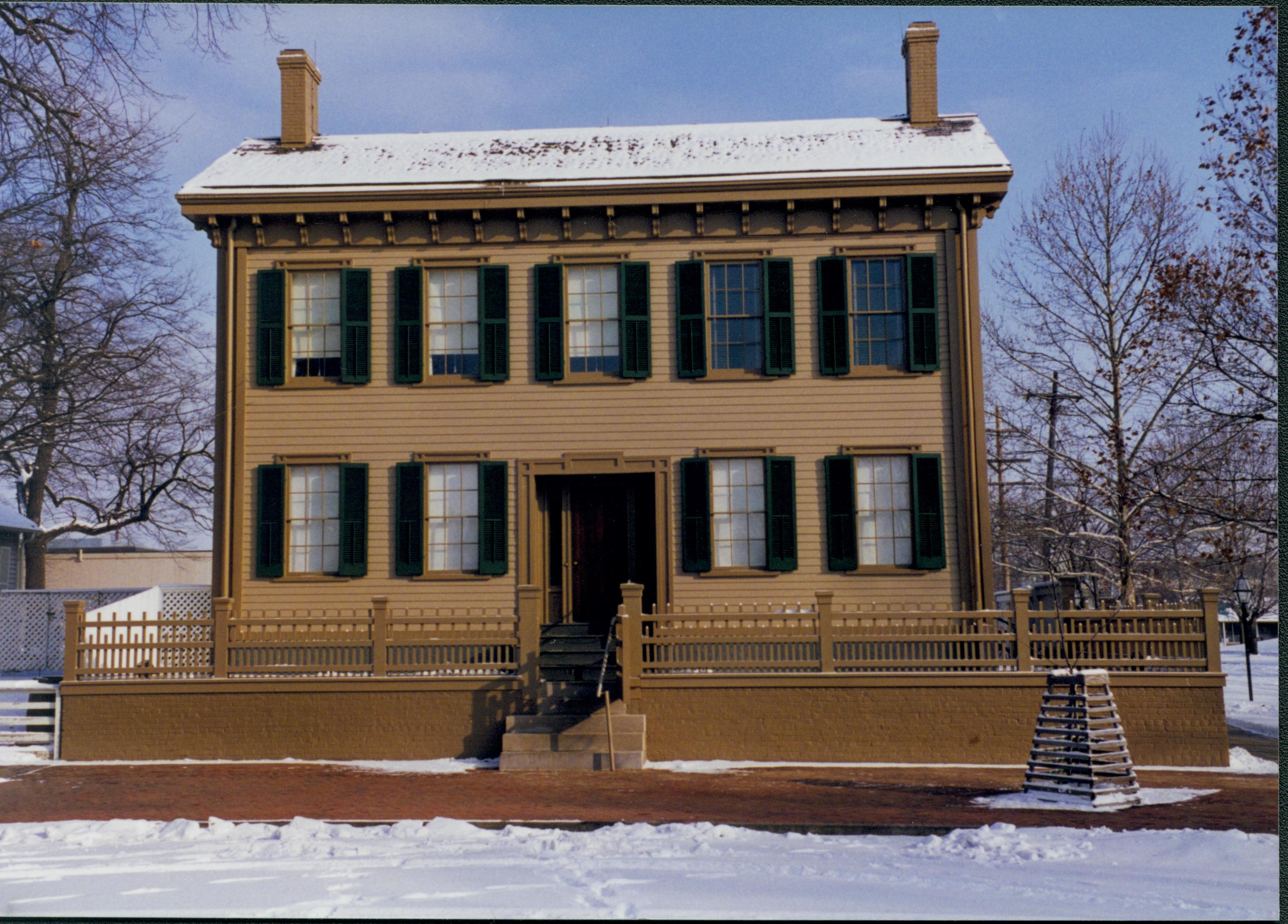 Lincoln Home in the snow from 8th Street.  Brick plaza cleared of snow in front, elm tree in cage at right, corner of Corneau House on far left Looking East from 8th Street snow, Lincoln Home, 8th Street, brick plaza