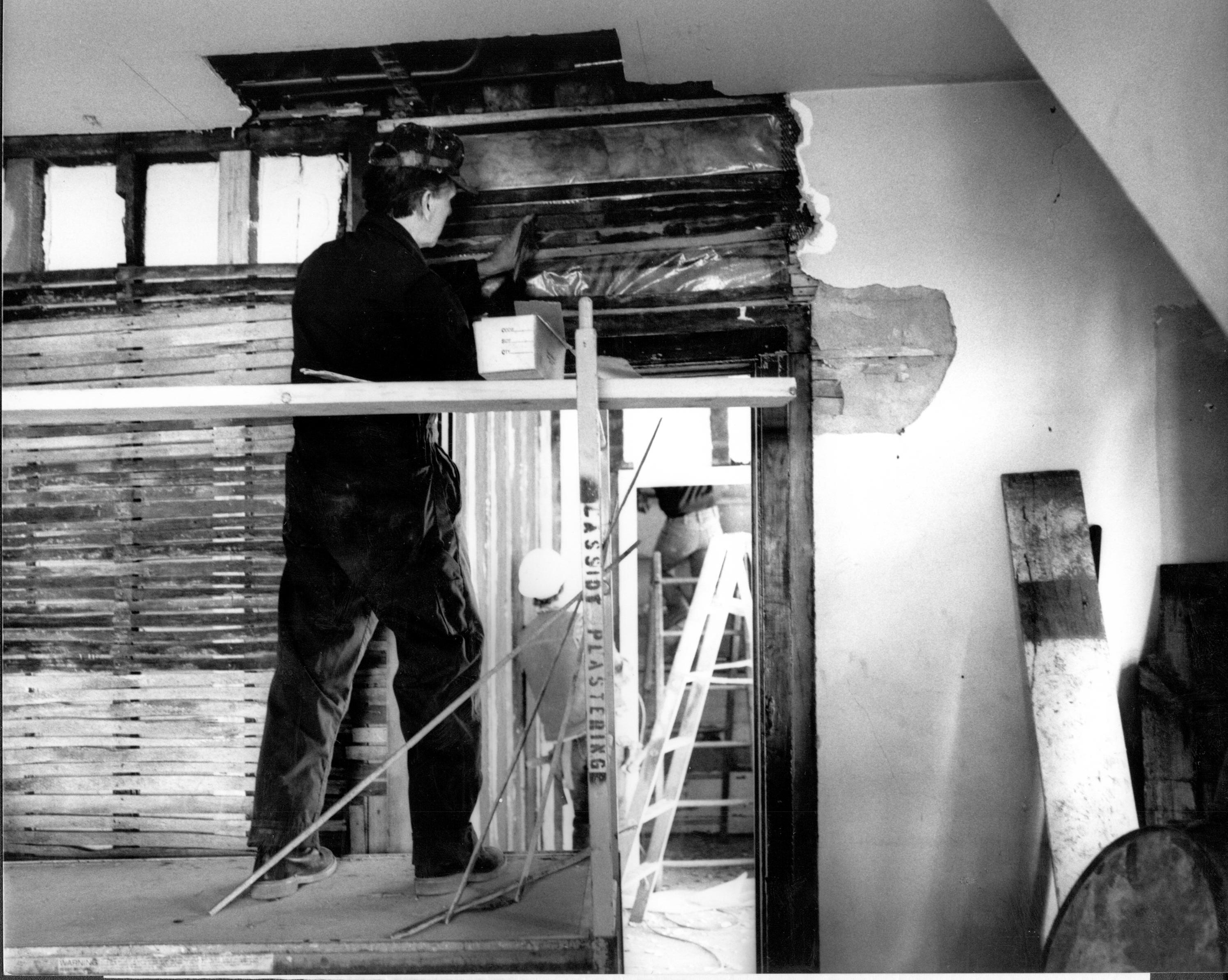 Joe Pree is preparing the interior wall of the kitchen in Lincoln's Home before repairing the plaster. Wherever possible, the original plaster and wall finishes are being preserved. The anticipated completion date for the project is June 16, 1988. Kitchen Lincoln, Home, Restoration, kitchen