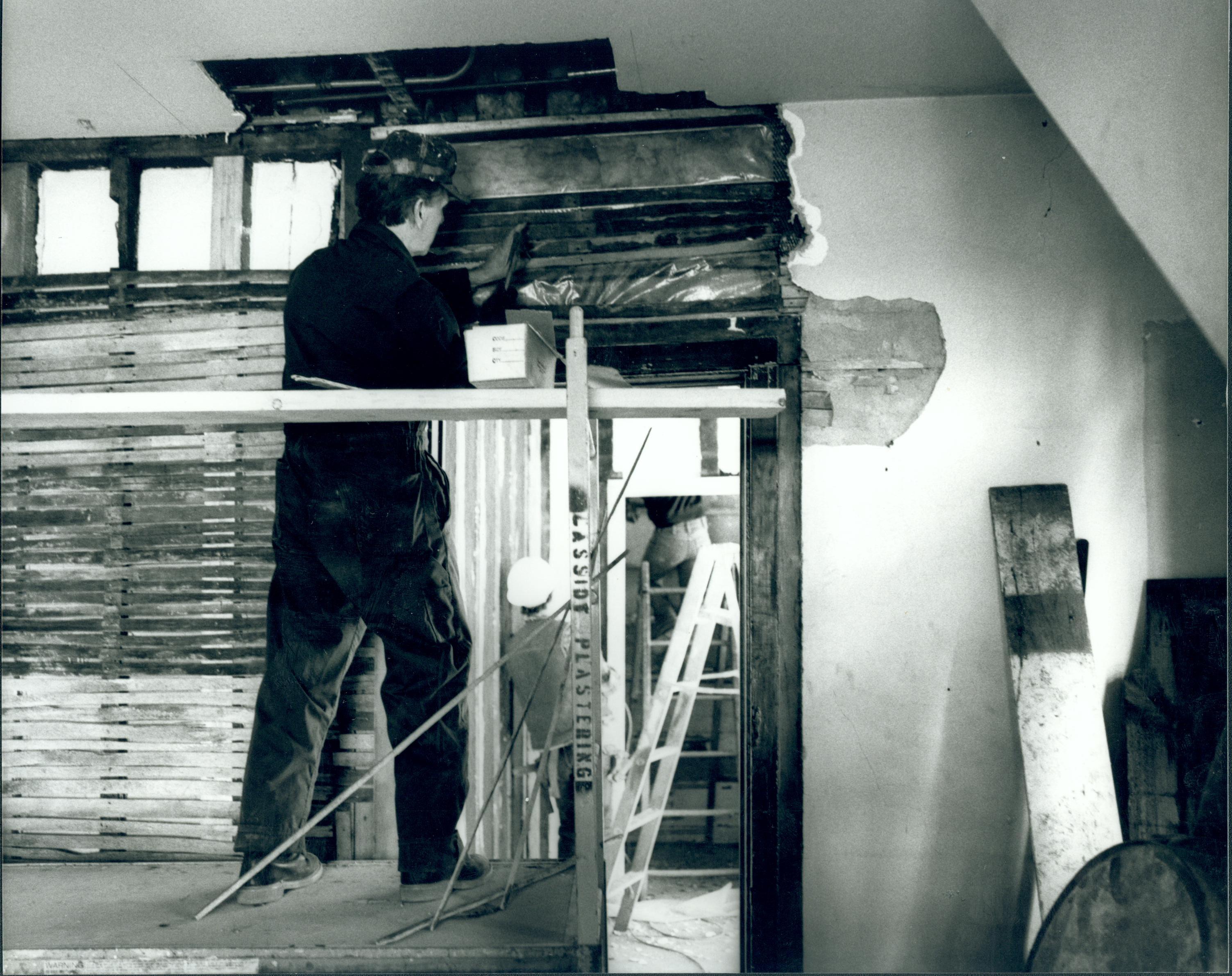 Joe Pree is preparing the interior wall of the kitchen in Lincoln's Home before repairing the plaster. Wherever possible, the original plaster and wall finishes are being preserved. The anticipated completion date for the project is June 16, 1988. Lincoln, Home, Restoration, kitchen