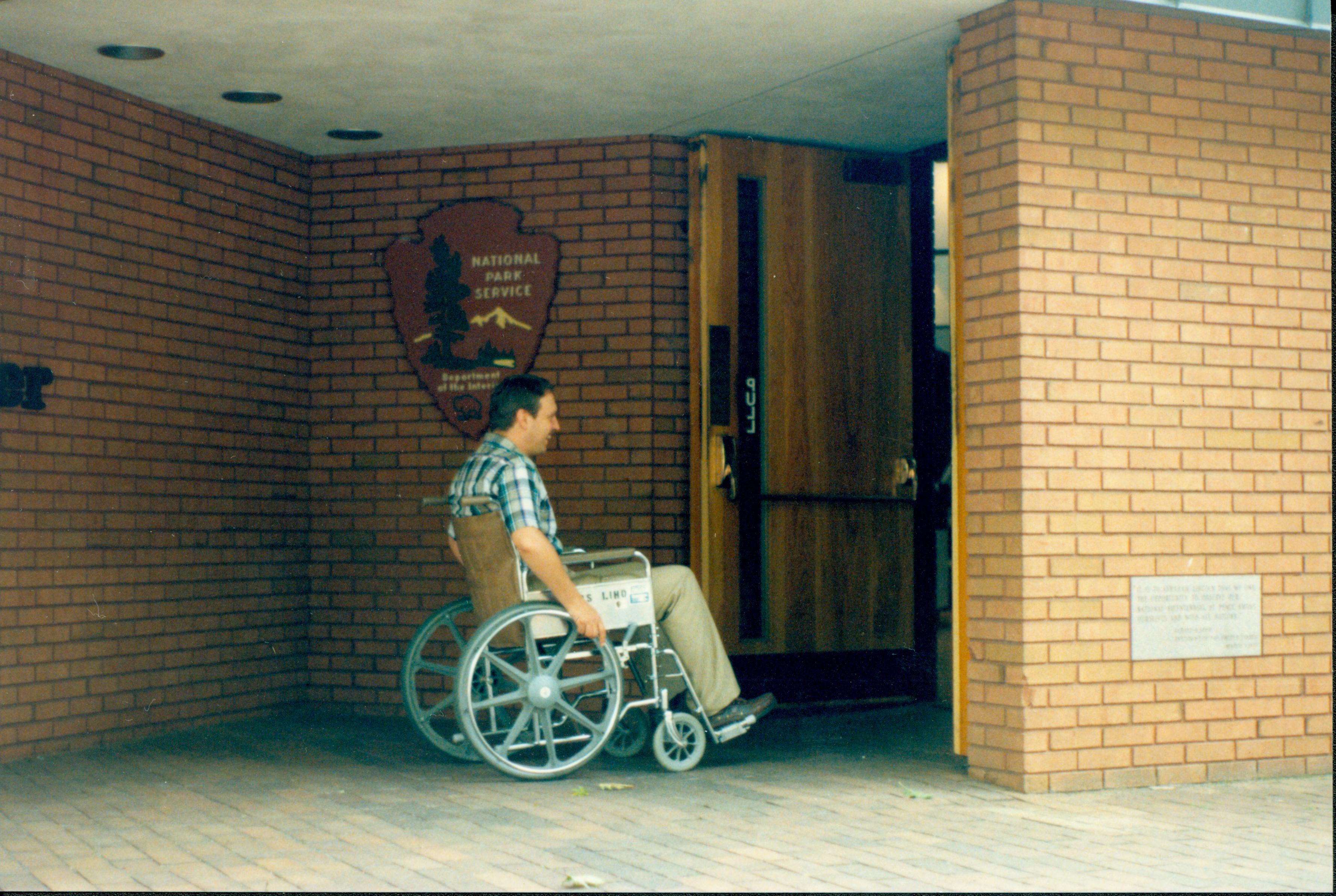 Bruce Krugar showing wheelchair accessibility to Visitor Center, 1991 Lift, Ramp, Handicap, Access