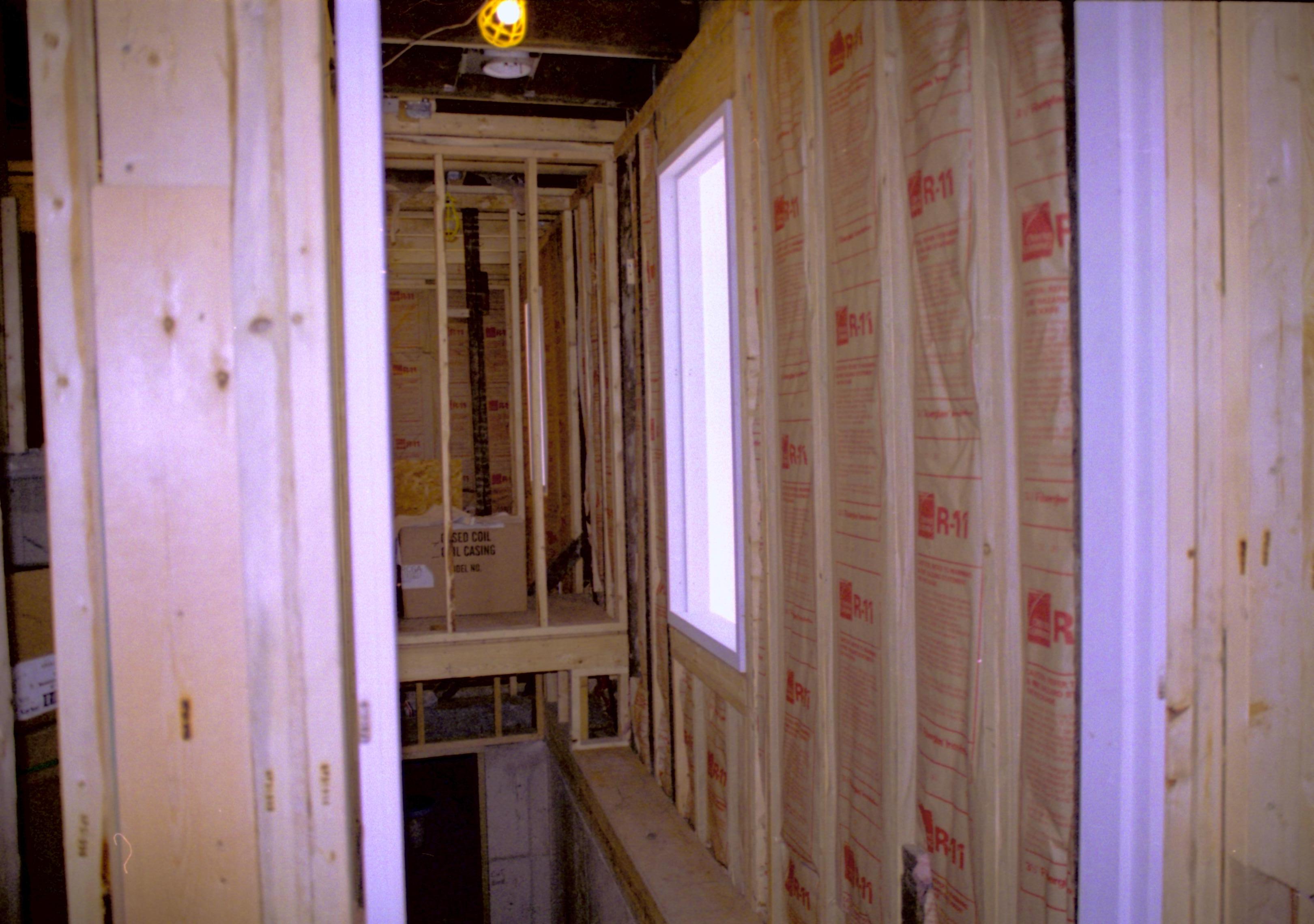 North Hallway, North wall and window being installed. At center/bottom of photo is stair case leading to basement Lincoln Home NHS, roll N9 Corneau, Arnold Barn, Sprigg, North Hallway and window renovation, construction