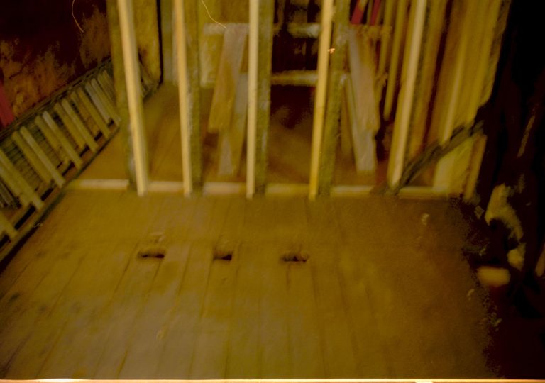 Room 105 and 104, Blurry. Photo taken looking west, from room 104 into room 105 (addition). Detail of floor and studs Lincoln Home NHS, roll N9 Corneau, Arnold Barn, Sprigg renovation