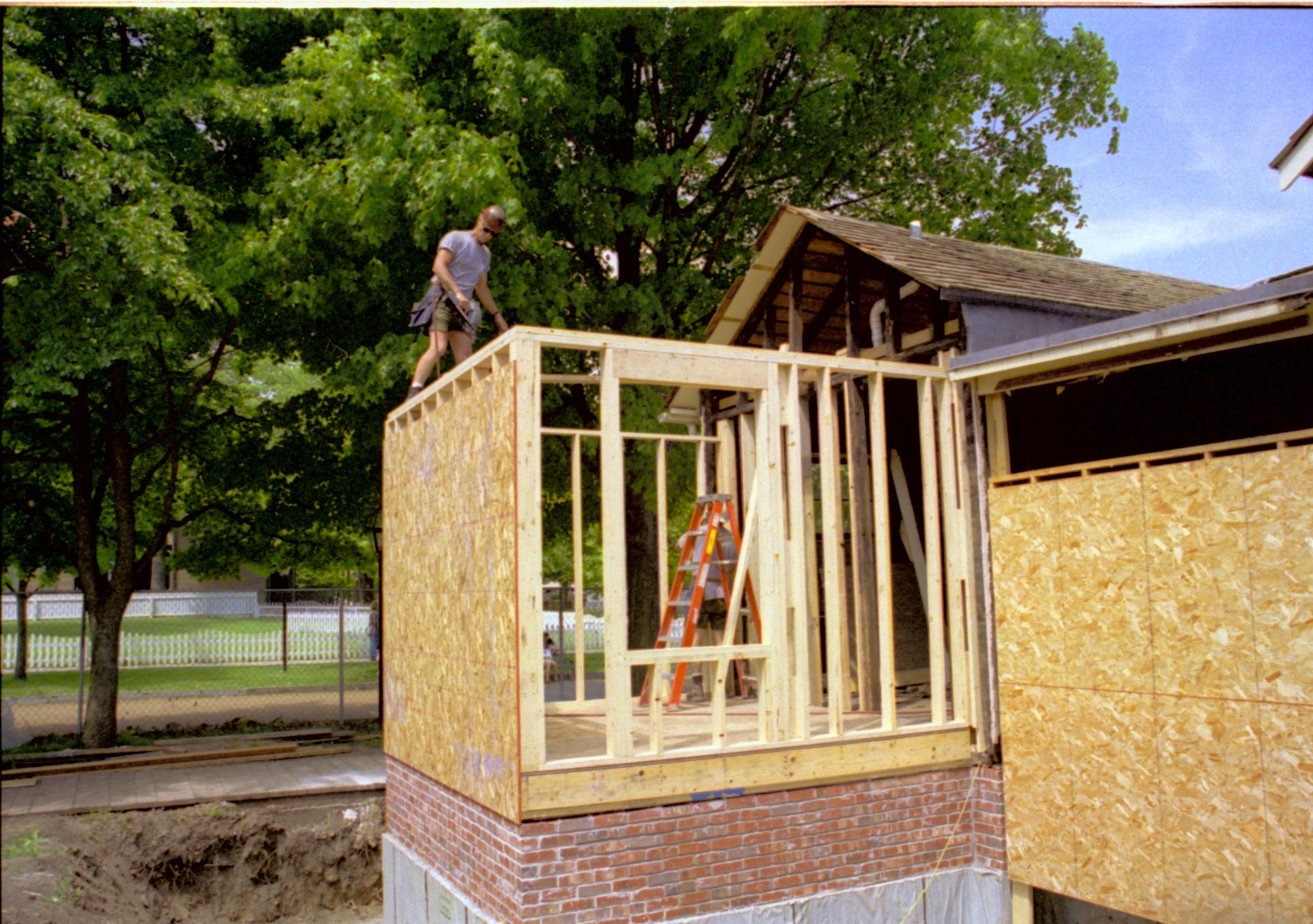 South and West wall and foundations of room 105. Plywood on west wall, South studs (and North in background) in place Lincoln Home NHS, HS-2, CRS Collection Move, Arnold Barn, Room 105, Roll N8, exp 12 Corneau, renovation
