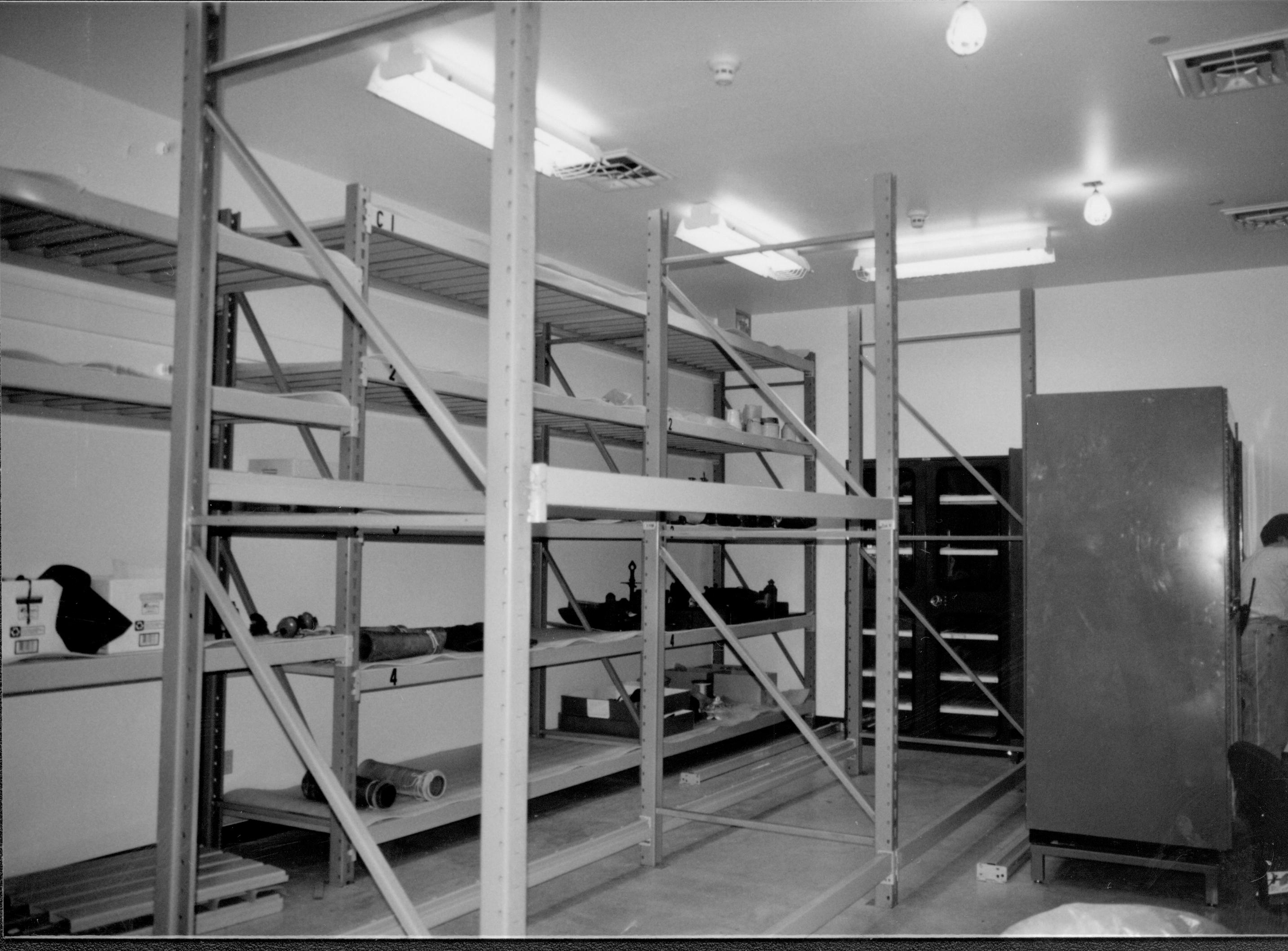 Room view during installation of artifacts Lincoln Home NHS, CRS Collection Move, Facing Northeast corner, Roll N10, exp 9 sheet 3 of 7 Arnold Barn, storage, artifacts