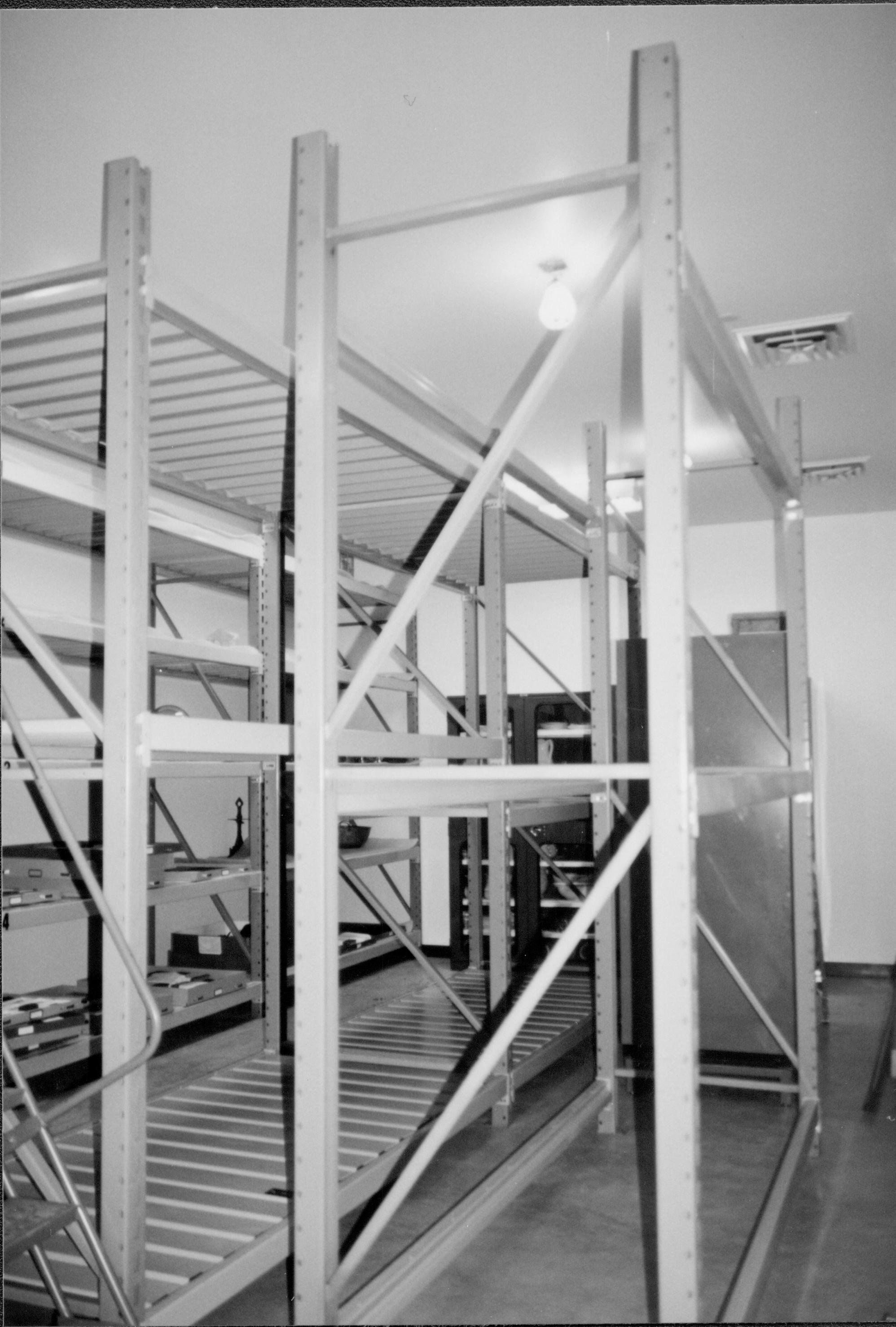 Standing at entrance (Southwest), looking Northeast across center racks during installation Lincoln Home NHS, CRS Collection Move, Facing Northeast Wall, Roll N10, exp 15 sheet 4 of 7 Arnold Barn, storage, artifacts