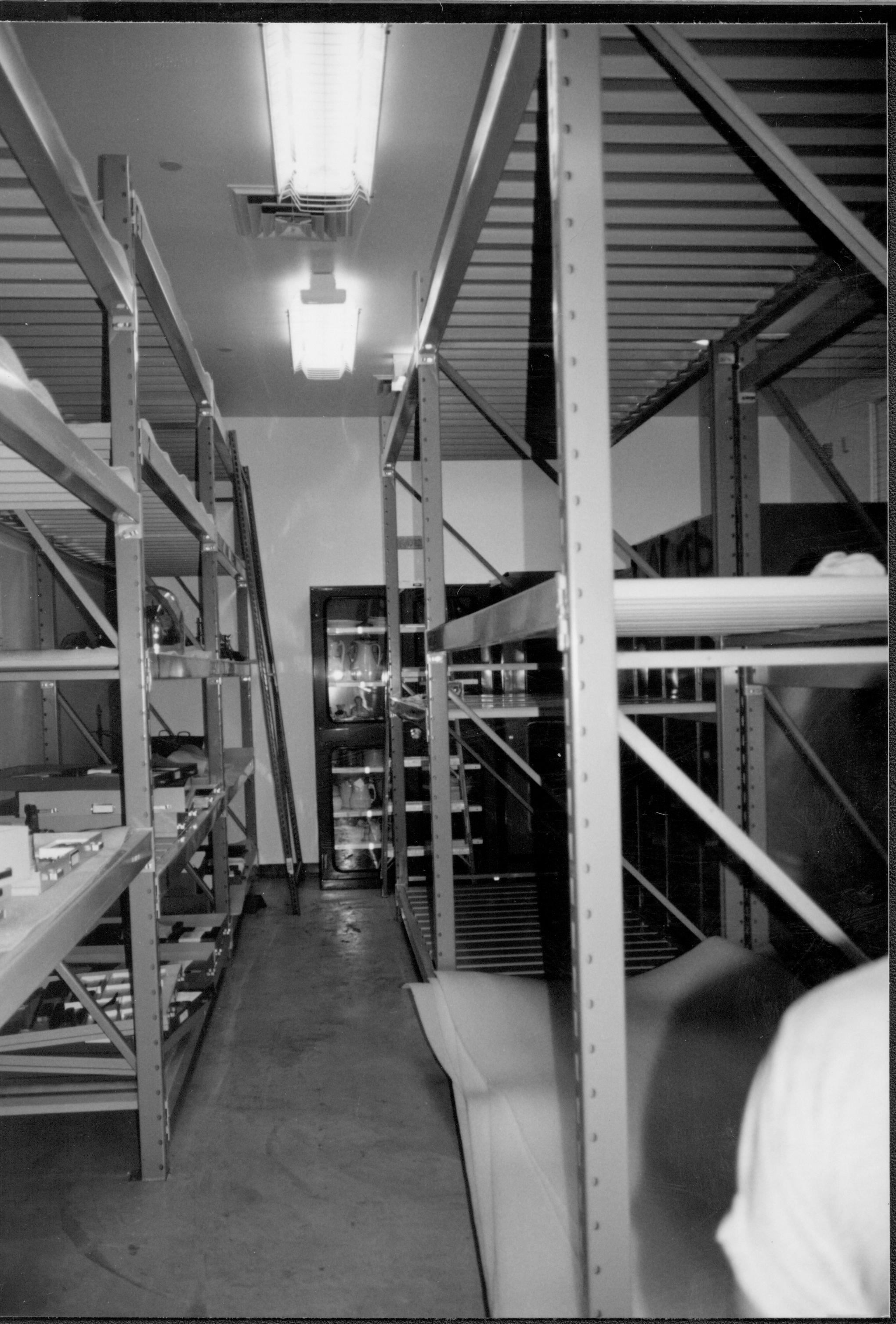 Artifacts for storage in book cabinets prepared for installation, temporarily housed on North wall storage shelves. Ethafoam prepared for installation in left foreground Lincoln Home NHS, CRS Collection Move, North and East Walls, Roll N10, exp 22 sheet 6 of 7 Arnold Barn, storage, artifacts