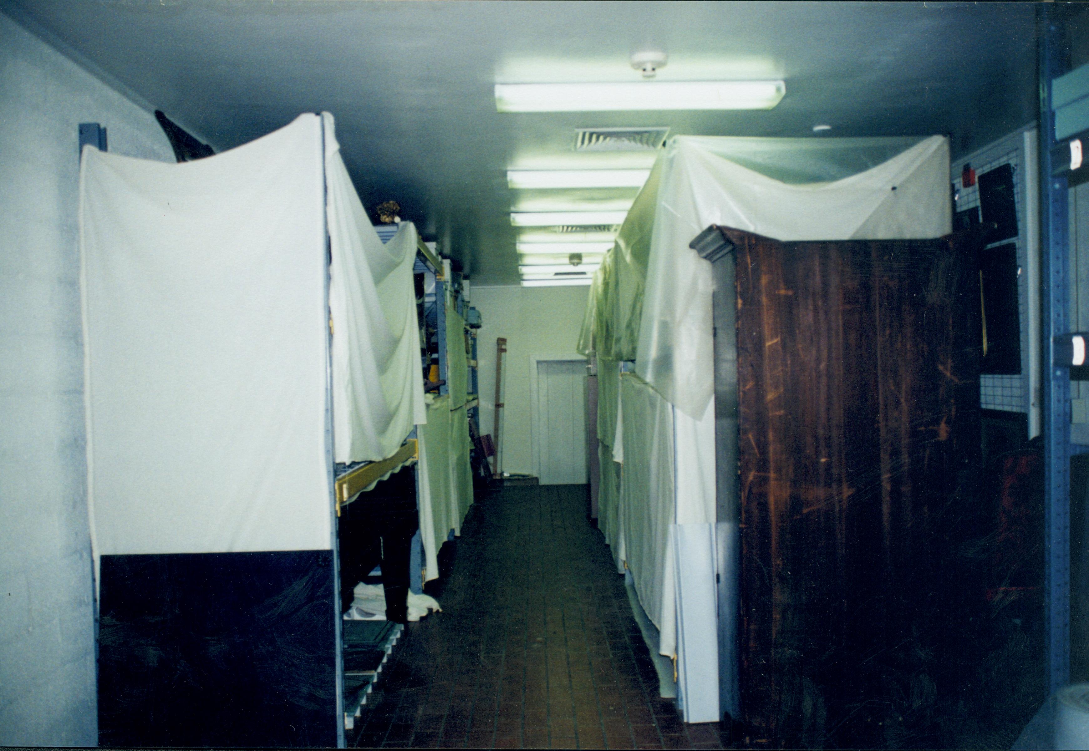 Looking at South wall and South entrance door (back is against North wall); view is along aisle between 4 foot racks Lincoln Home NHS, 1998 CRS Collection Move, Roll N7, exp 4 sheet 2 of 9 Carriage House, storage room