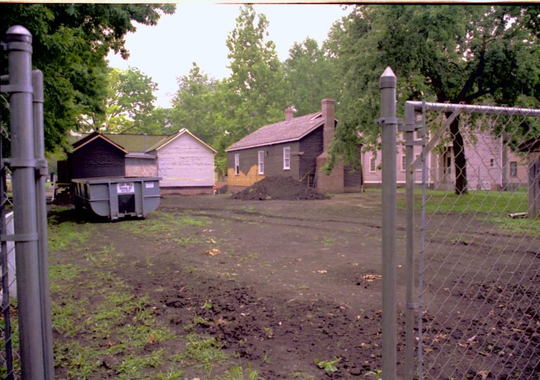 Northwest corner- photo taken looking across West end of Corneau House lot (Sprigg House on right). North and West walls form a distance Lincoln Home NHS, CRS Artifacts Move, Beedle, Lyon, Corneau, Roll N13, exp 15 Sprigg House, renovation