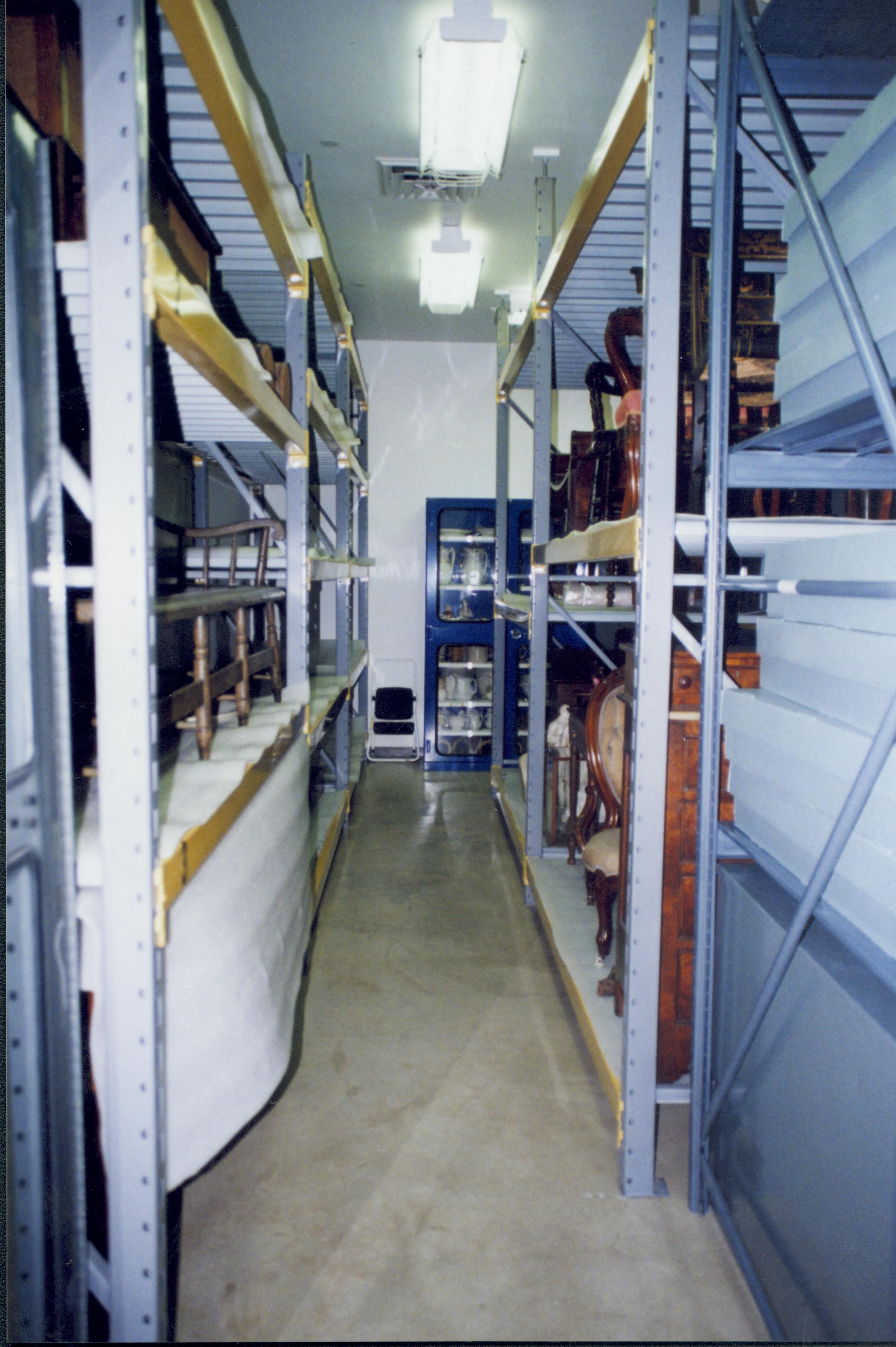 North aisle; photo taken looking East. Artifacts in their new storage locations Lincoln Home NHS, CRS Artifacts Move, Roll N13, exp 29 sheet 5 of 6 Arnold Barn, storage room, artifacts