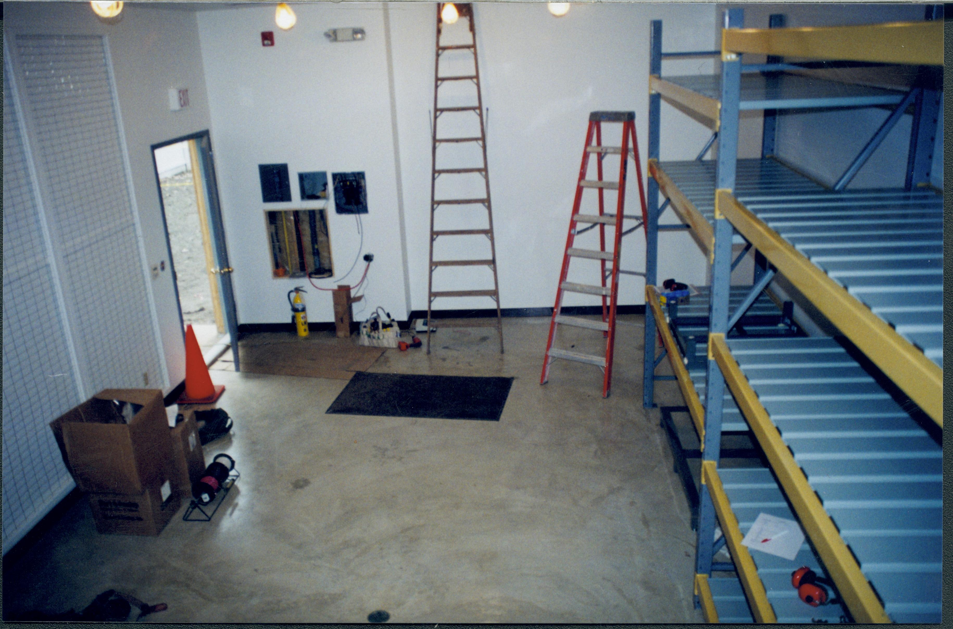 North wall and Northeast corner- Photo taken looking Northeast along North wall; Northwest corner of structure at right of photo. New storage shelves just installed Lincoln Home NHS, Roll N6 sheet 1 of 2, Arnold House and Propety, exp 14 renovation, Arnold Barn