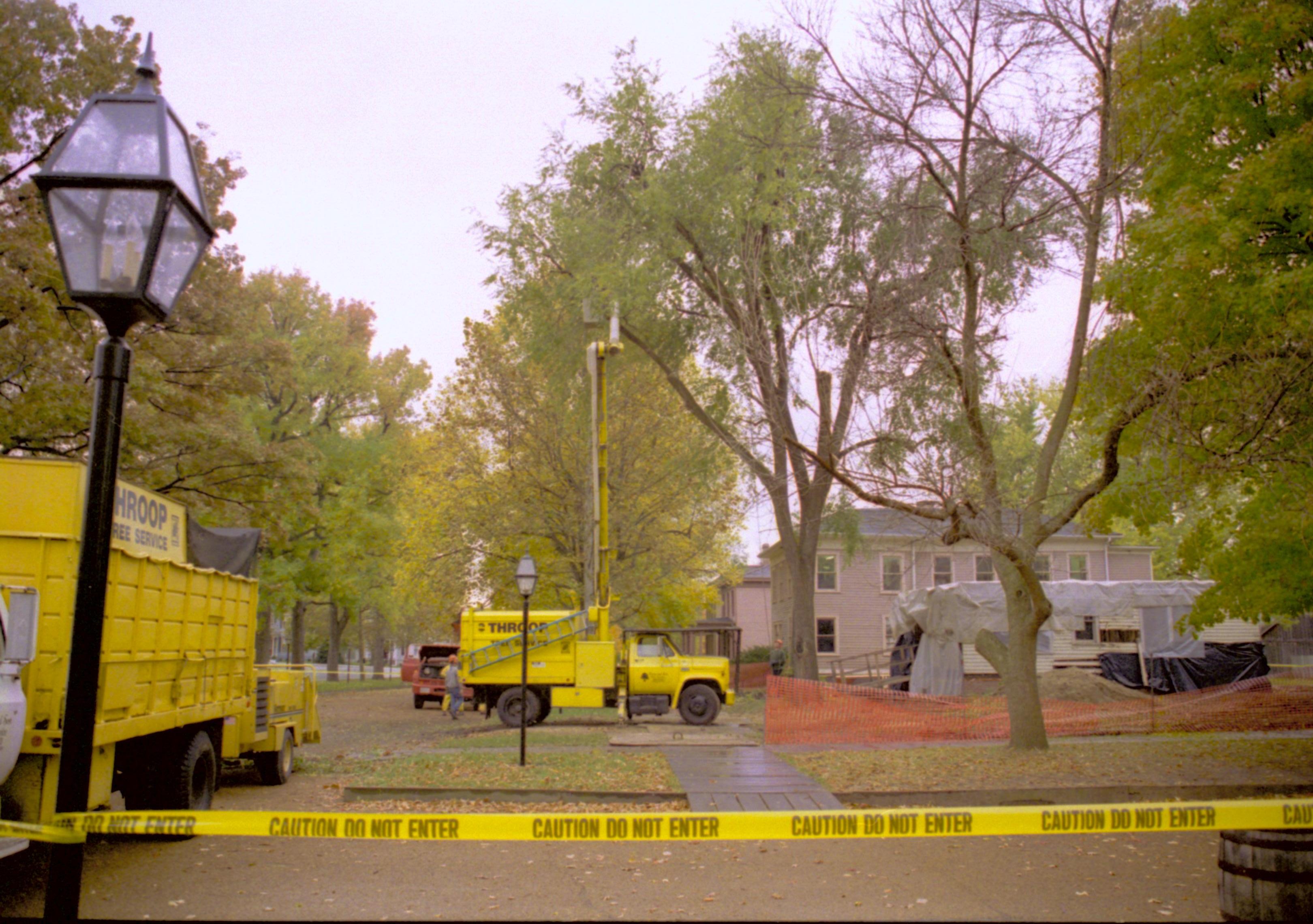 South face of west side of 8th St; Cutting down trees at Southwest corner of 8th/Jackson intersection in prep of moving Corneau House to front of lot. In background can see Sprigg under construction Lincoln Home NHS, Roll N5, exp 1, sheet 1 of 2 LIHO, Sprigg, Corneau