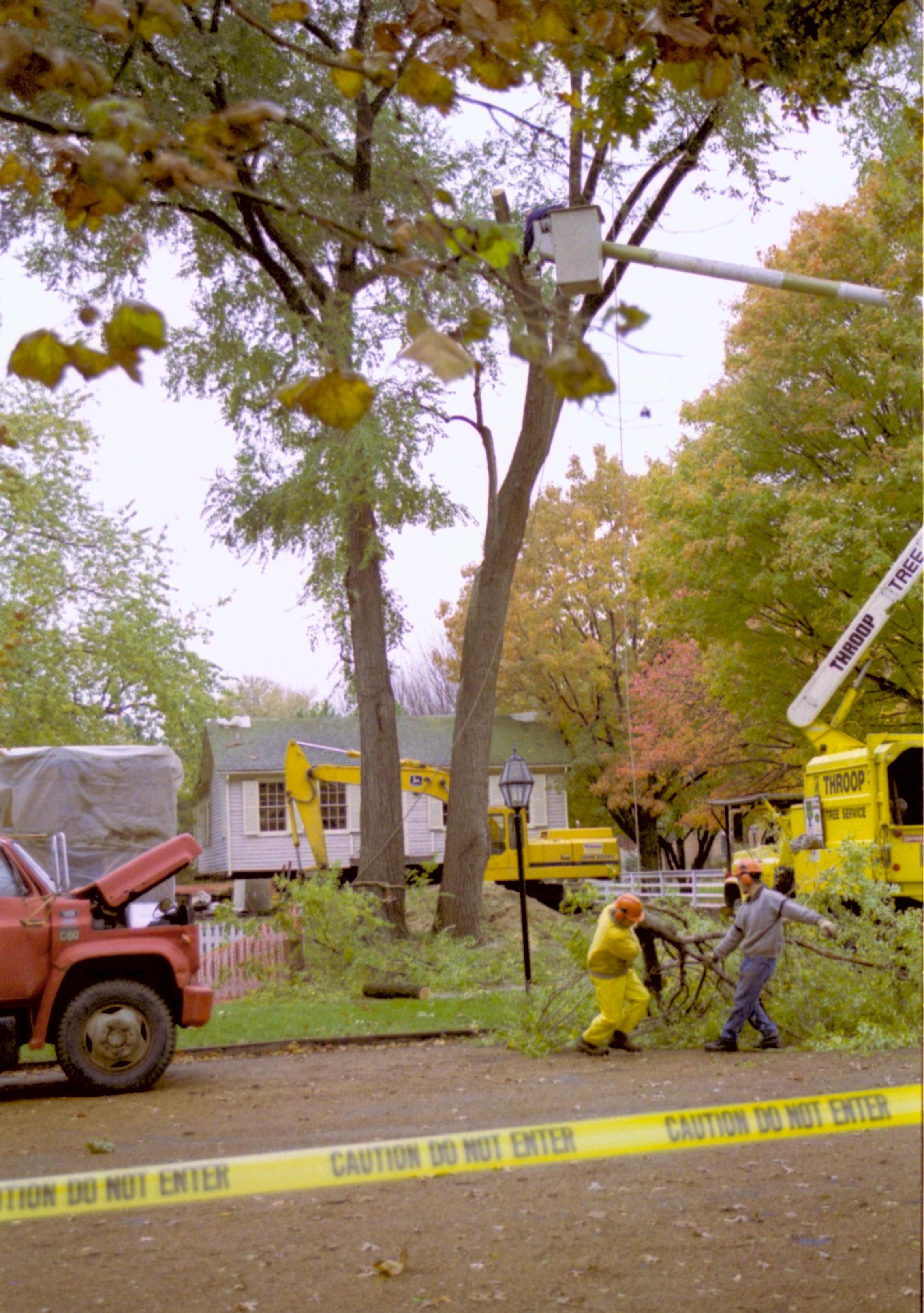 West face 8th St. and Corneau; Cutting down trees at Southwest corner of 8th/Jackson intersection in prep of moving Corneau House to front of lot. East elevation in background. Photo taken from East side of 8th St. Lincoln Home NHS, Roll N5, exp 4, sheet 1 of 2 LIHO, Corneau