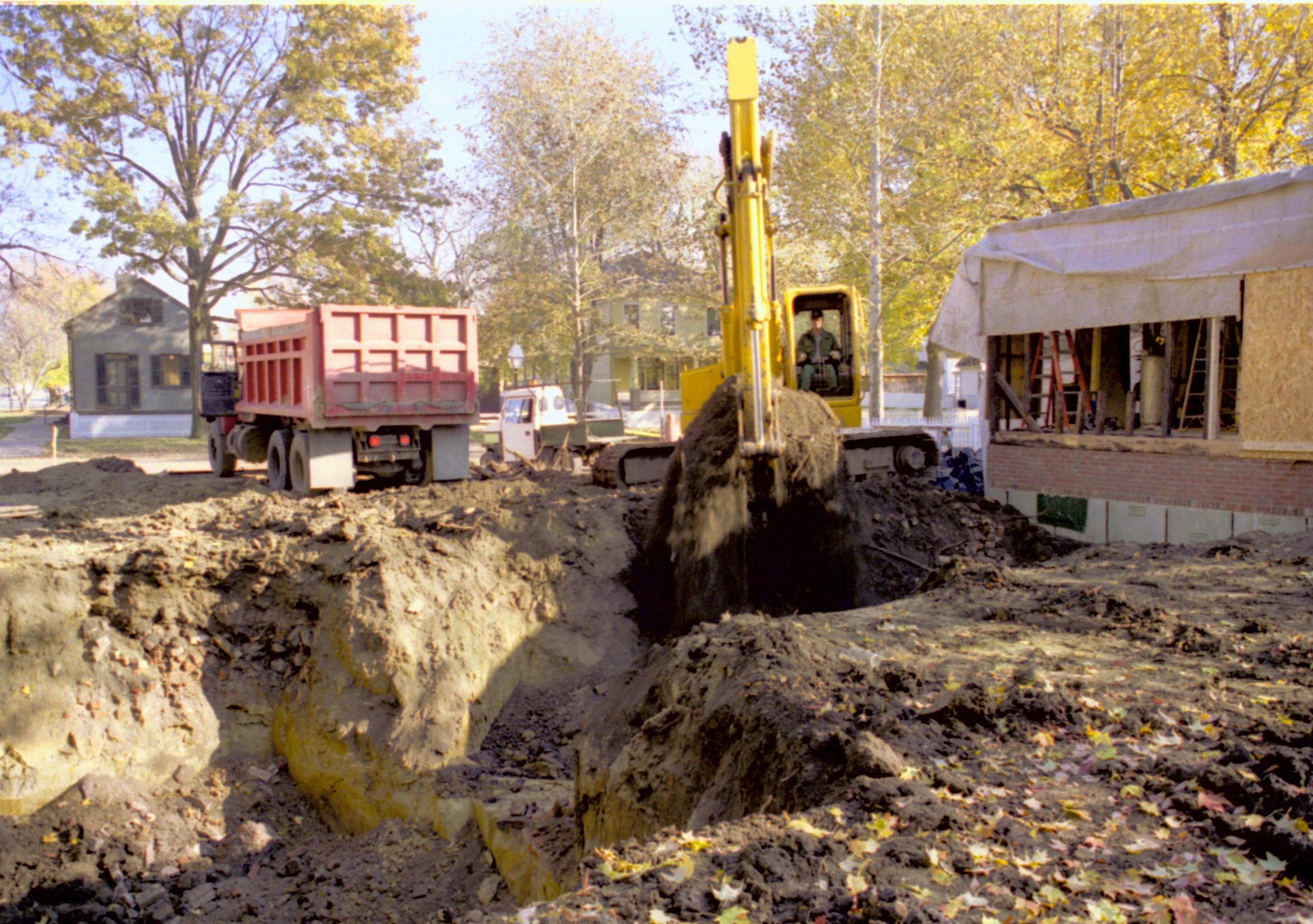 Excavating foundations for Corneau (Pollock operating digger). North wall Sprigg, Northwest corner Cook and West wall Arnold in background Lincoln Home NHS, Corneau lot facing Southeast, Roll N5, exp 16, sheet 1 of 2 LIHO, Corneau, excavation