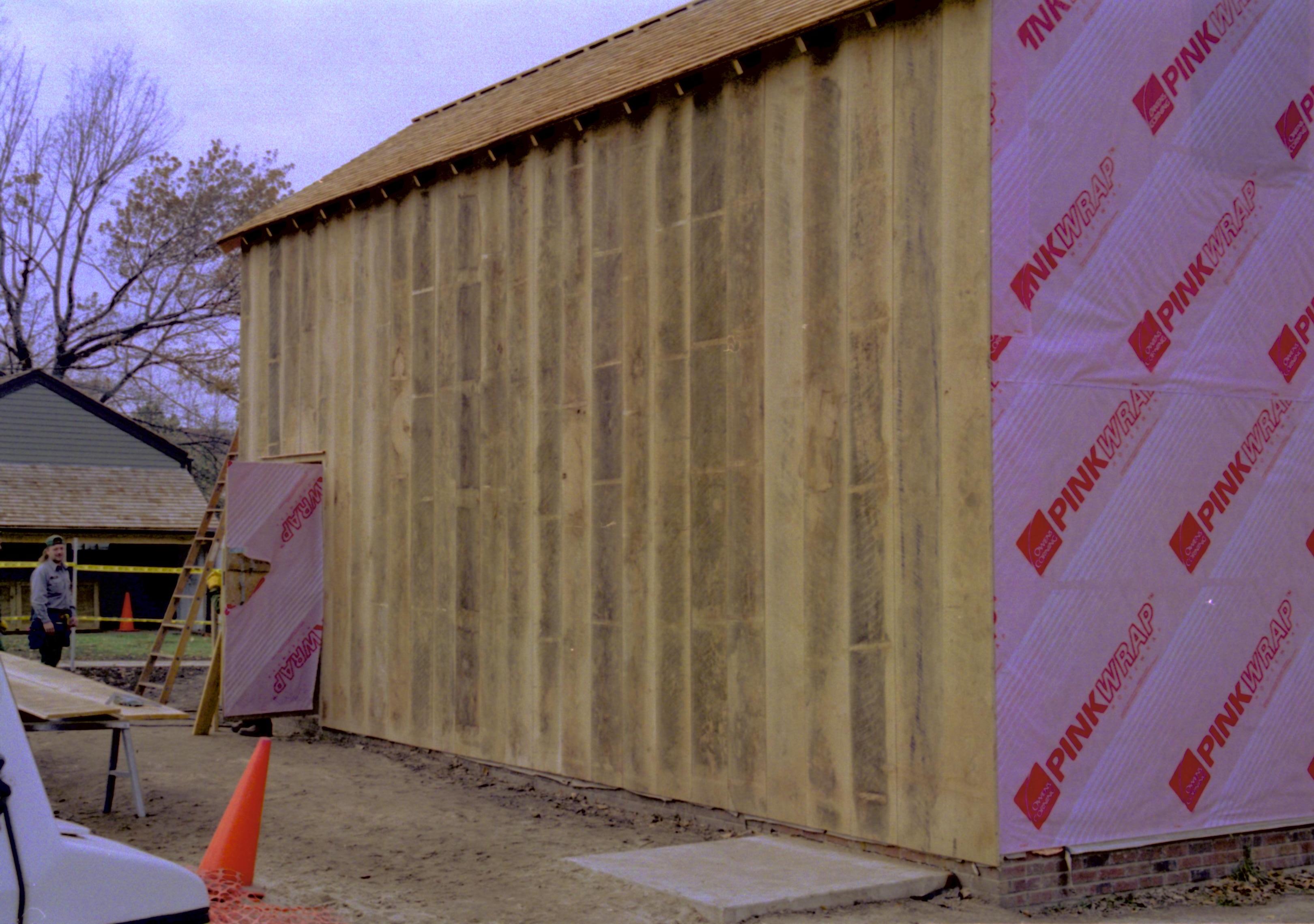 South entrance and South wall siding visible. East wall covered in Pink Wrap, attic entry door visible Lincoln Home NHS, Southeast Corner, Roll N5, exp 17, sheet 1 of 2 LIHO, Arnold Barn, excavation