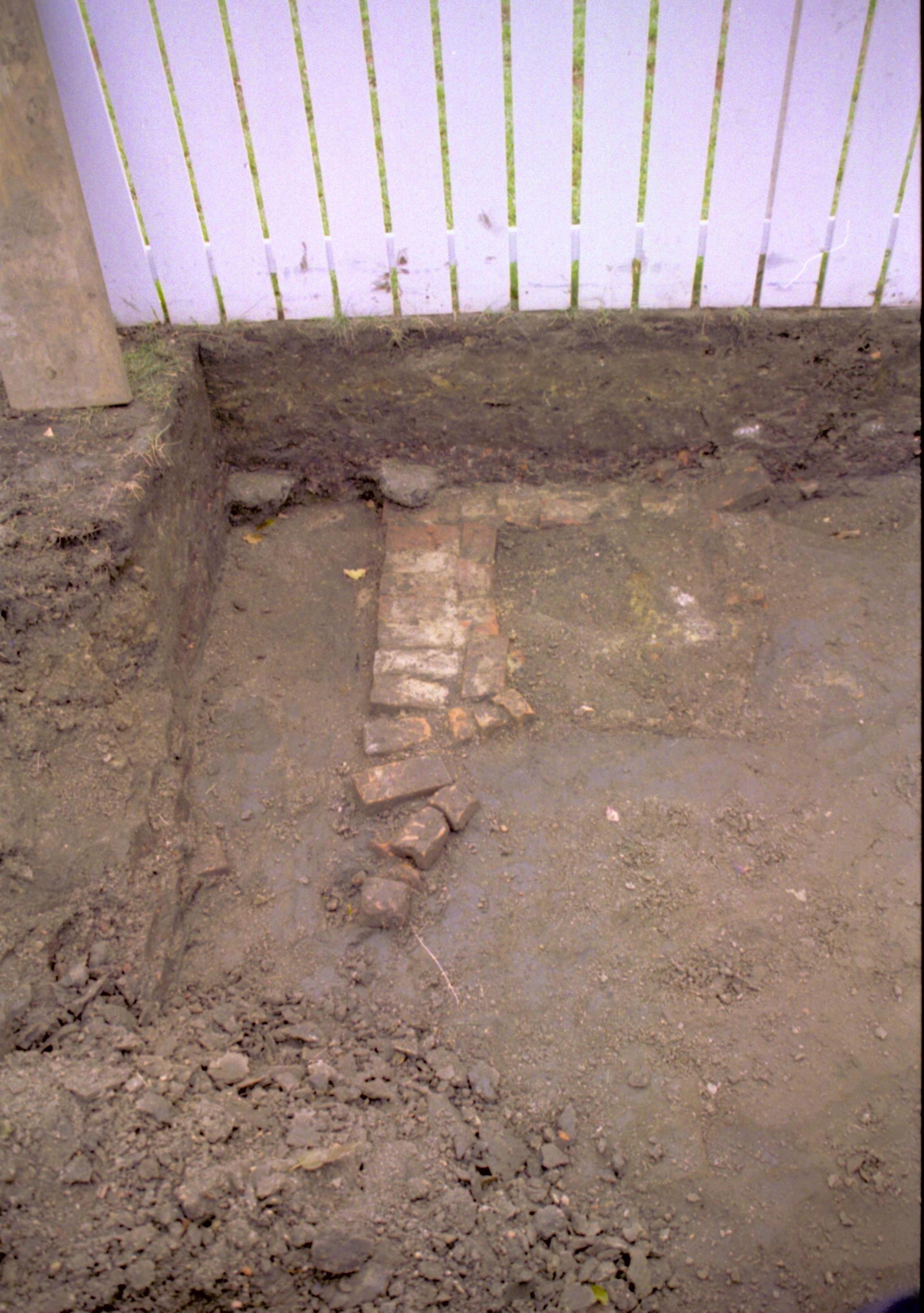 Feature discovered at Southwest edge of excavation. Privy feature photographed standing on boardwalk at West end of dig, looking South (South property fence in background) Lincoln Home NHS, Facing South at rear of lot, Roll N5, exp 23, sheet 2 of 2 LIHO, Dean, excavation