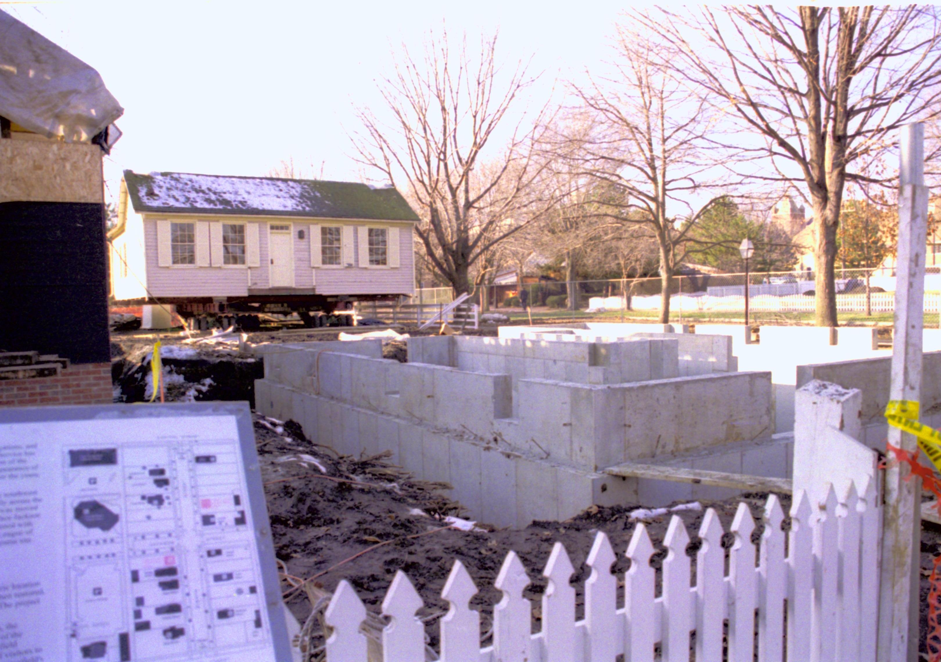 Sothwest corner of foundation in foreground (photographed looking Northwest across lot.) Corneau House standing in back of lot; East wall visible Lincoln Home NHS, Looking Northwest, Roll N5, exp 24, sheet 2 of 2 LIHO, Corneau, excavation