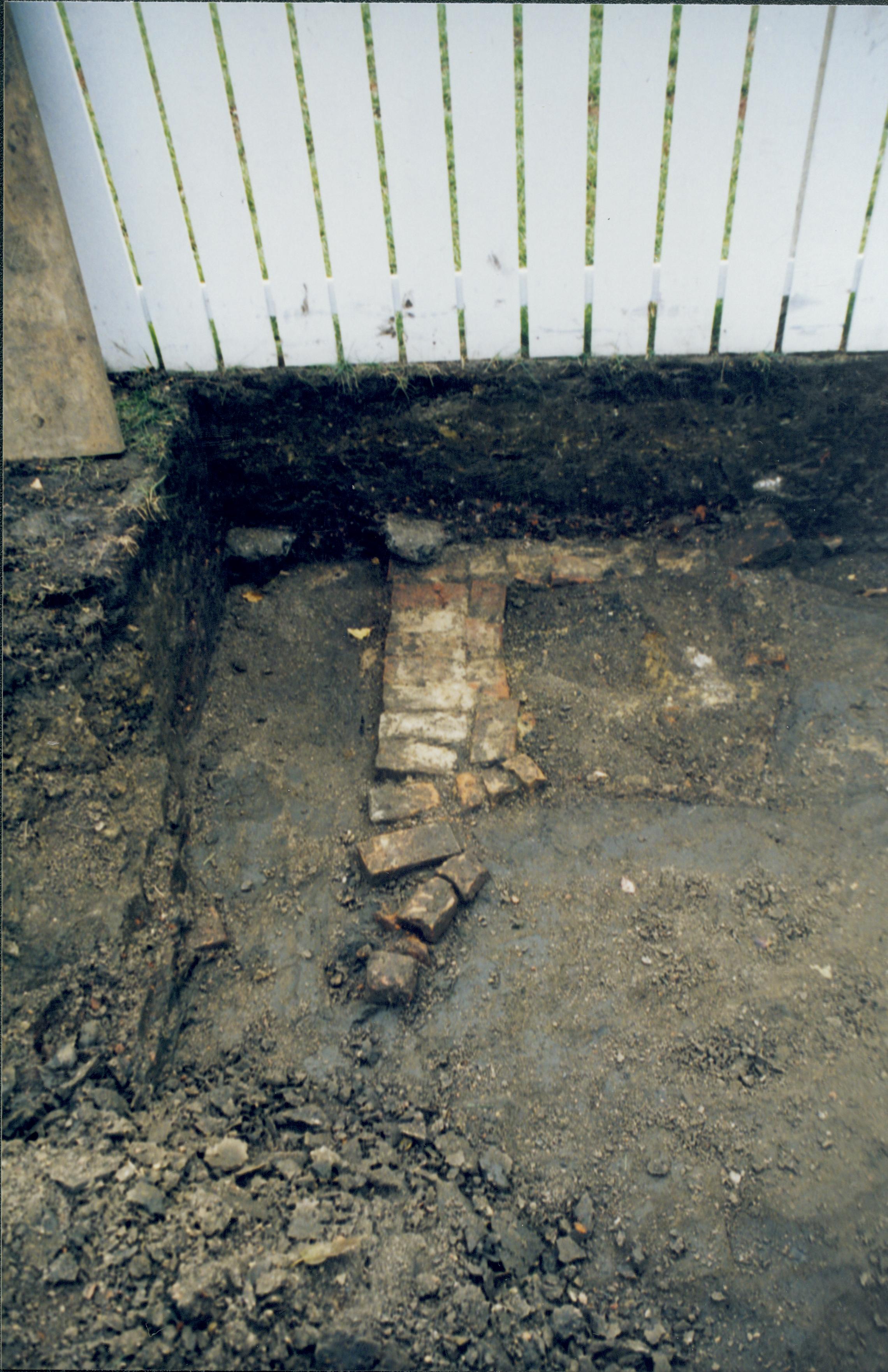 Dean House, Feature discovered at Southwest edge of excavation. Privy feature photographed standing on boardwalk at West end of dig, looking South (south property fence in background) Lincoln Home NHS- Dean House, roll N5 exp 23 Dean House, excavation