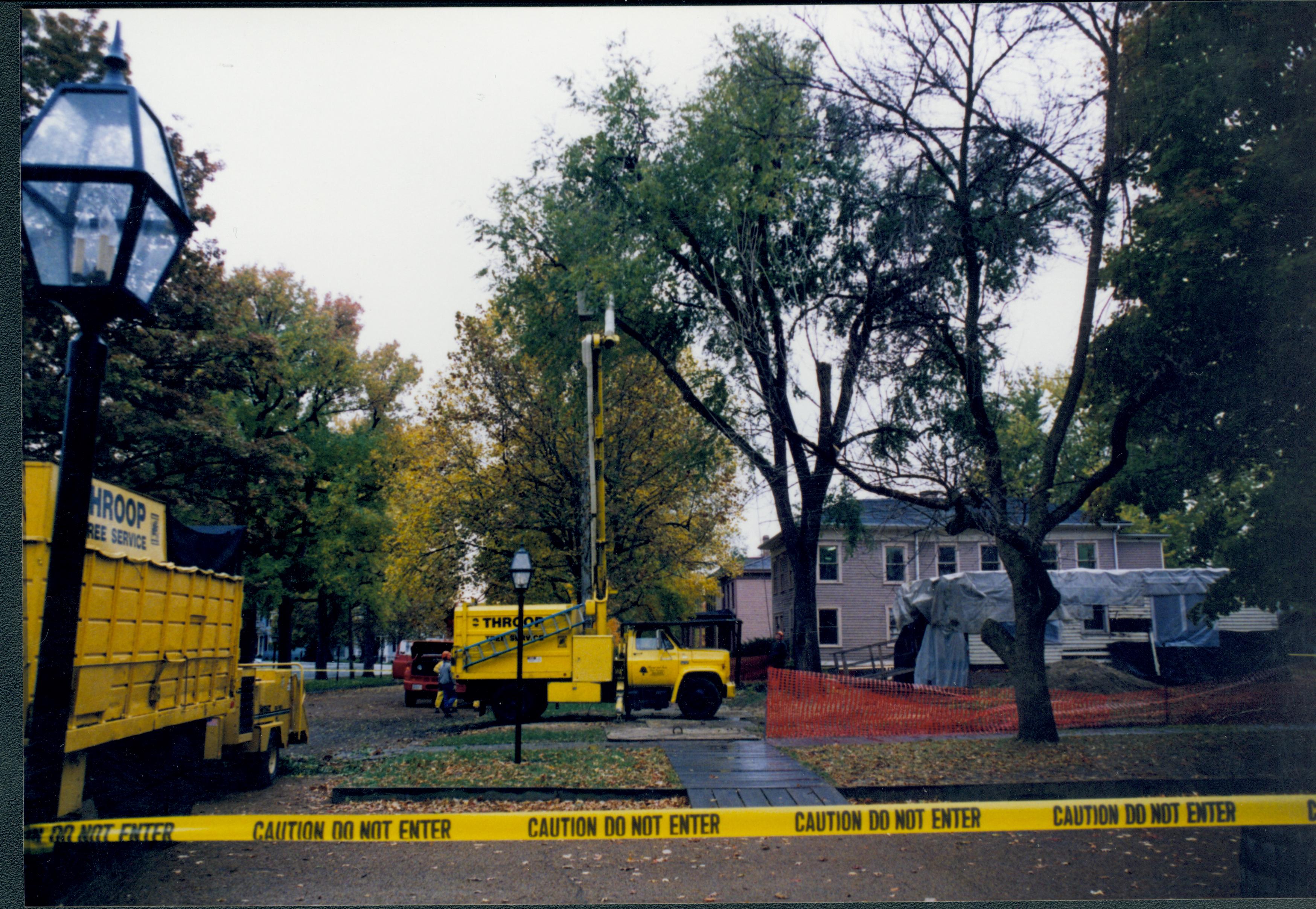 Cutting down trees at Southwest corner of 8th/Jackson intersection; in prep for moving Corneau House to front of lot. In background can see Sprigg under construction Lincoln Home NHS- Corneau House and Lot, Roll N5 exp 1 Corneau, move